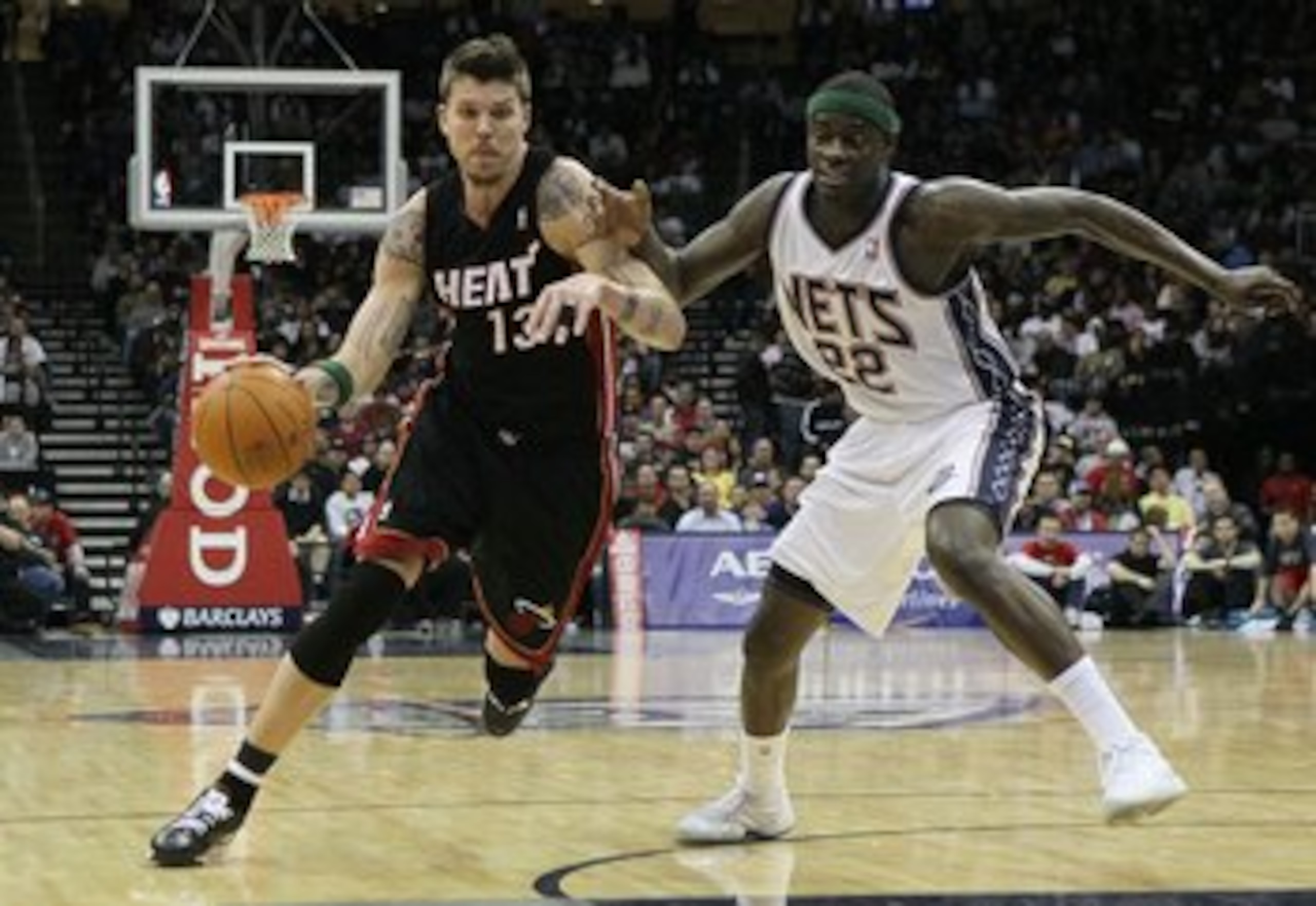 NEWARK, NJ - APRIL 03:  Mike Miller #13 of the Miami Heat drives against Anthony Morrow #22 of the New Jersey Nets at the Prudential Center on April 3, 2011 in Newark, New Jersey.NOTE TO USER: User expressly acknowledges and agrees that, by downloading an