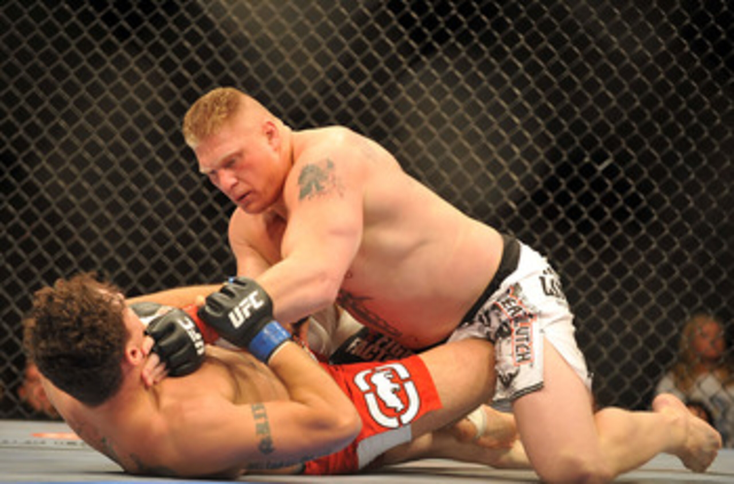 LAS VEGAS - JULY 11:  Brock Lesnar holds down Frank Mir during their heavyweight title bout during UFC 100 on July 11, 2009 in Las Vegas, Nevada. Lesnar defeated Mir by a second round knockout.  (Photo by Jon Kopaloff/Getty Images)