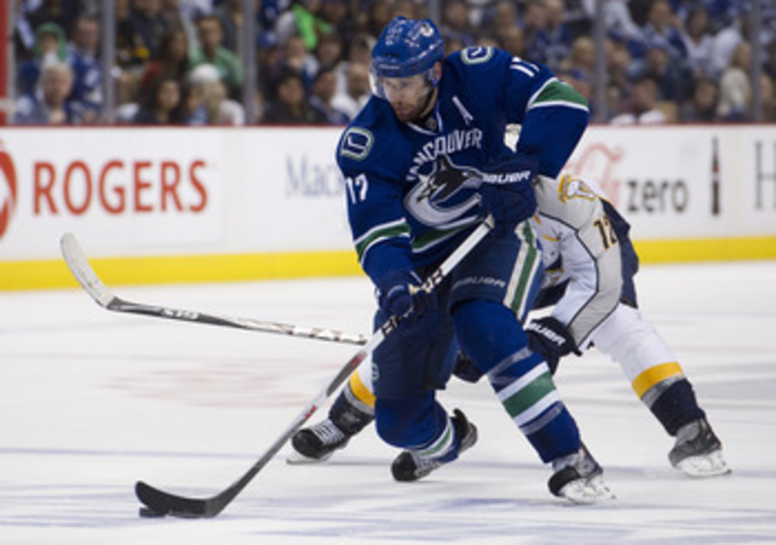 VANCOUVER, CANADA - MAY 7: Ryan Kesler #17 of the Vancouver Canucks skates with the puck while being pursued by Mike Fisher #12 of the Nashville Predators during the third period in Game Five of the Western Conference Semifinals during the 2011 NHL Stanle