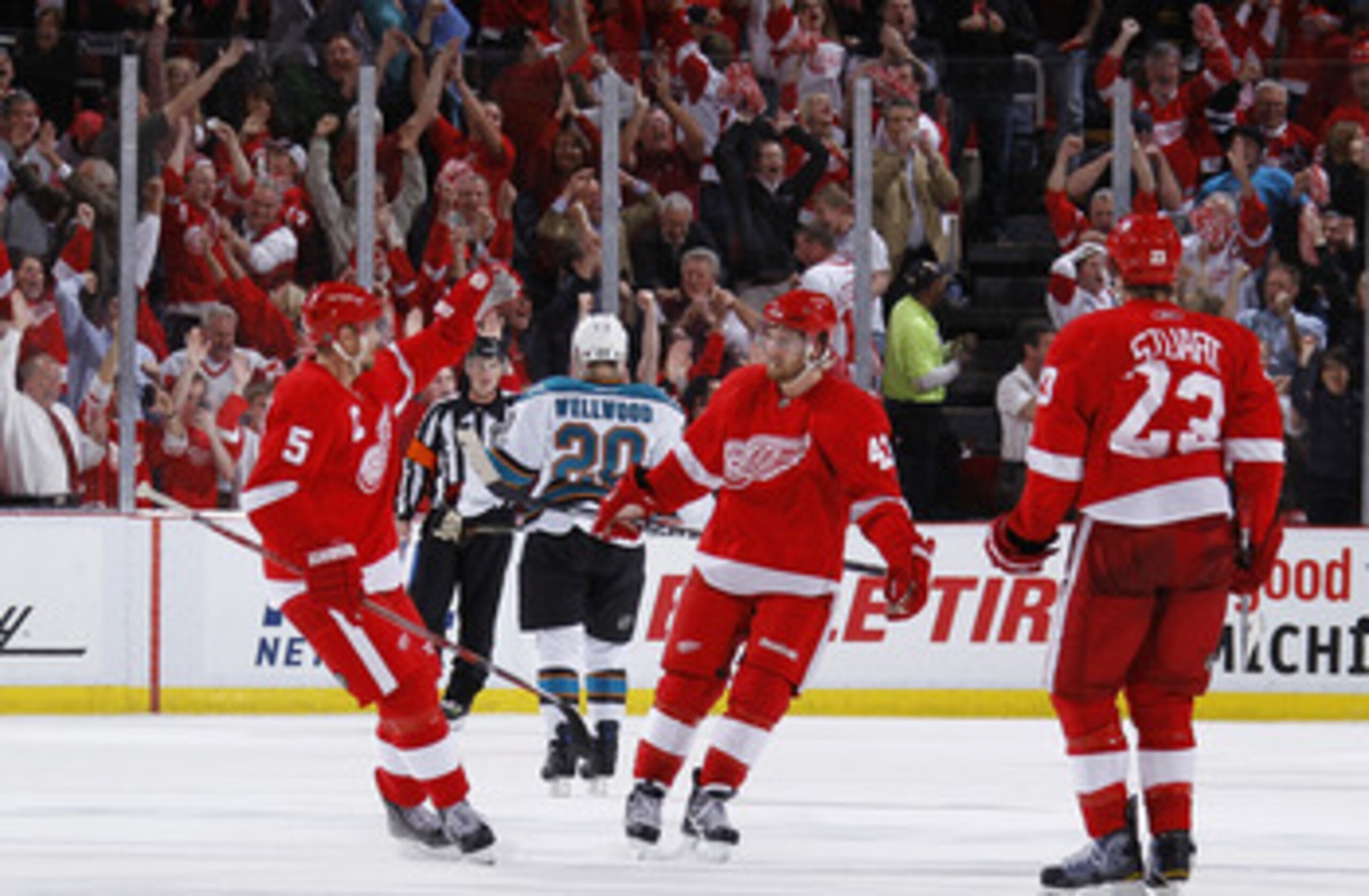 DETROIT - MAY 10: Darren Helm #43 of the Detroit Red Wings celebrates his third period empty net goal with Nicklas Lidstrom #5 and Brad Stuart #23 while playing the San Jose Sharks in Game Six of the Western Conference Semifinals during the 2011 NHL Stanl