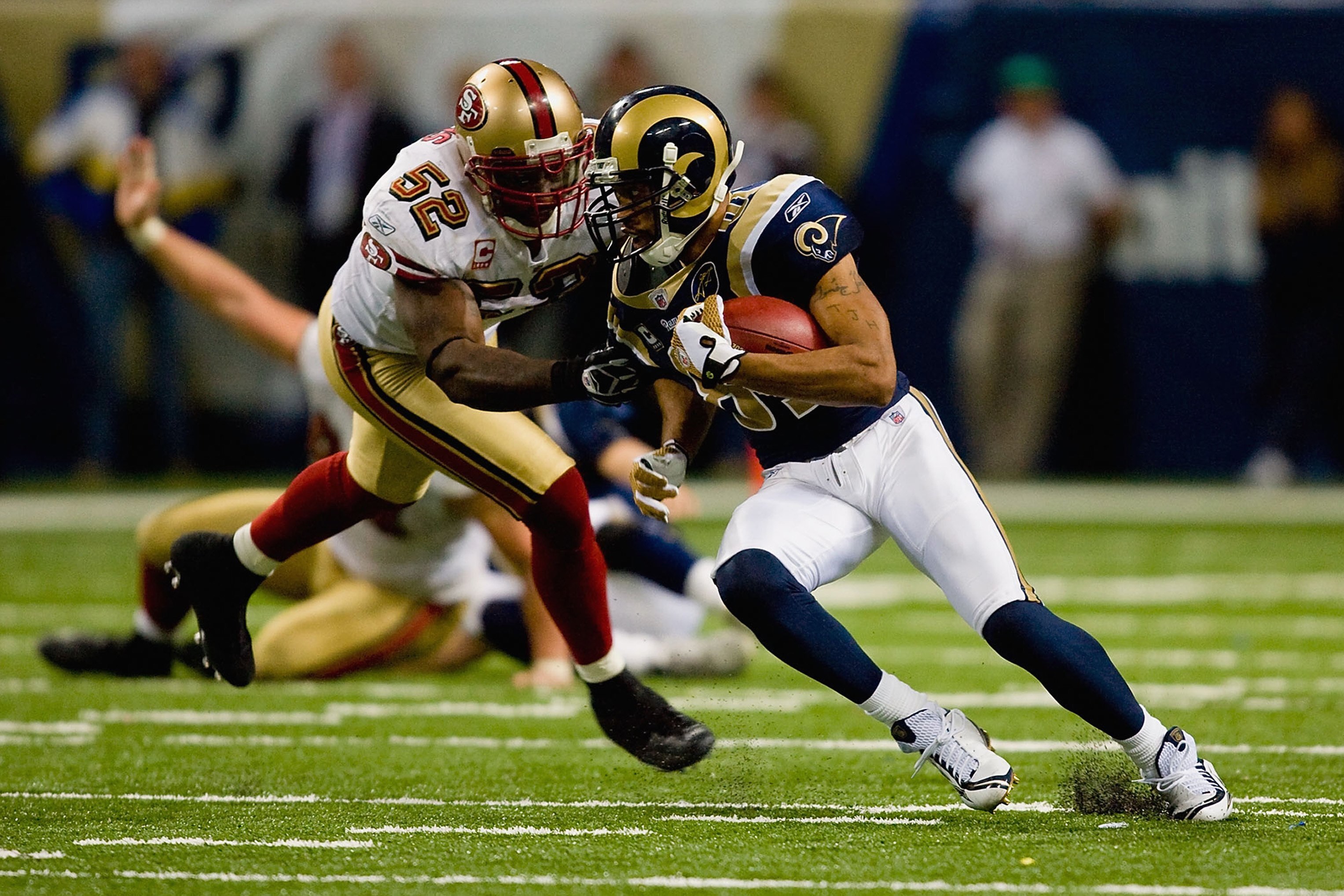 ST. LOUIS, MO - DECEMBER 21:  Torry Holt #81 of the St. Louis Rams carries the ball against Patrick Willis #52 of the San Francisco 49ers at the Edward Jones Dome on December 21, 2008 in St. Louis, Missouri. The 49ers won 17-16. (Photo by Dilip Vishwanat/