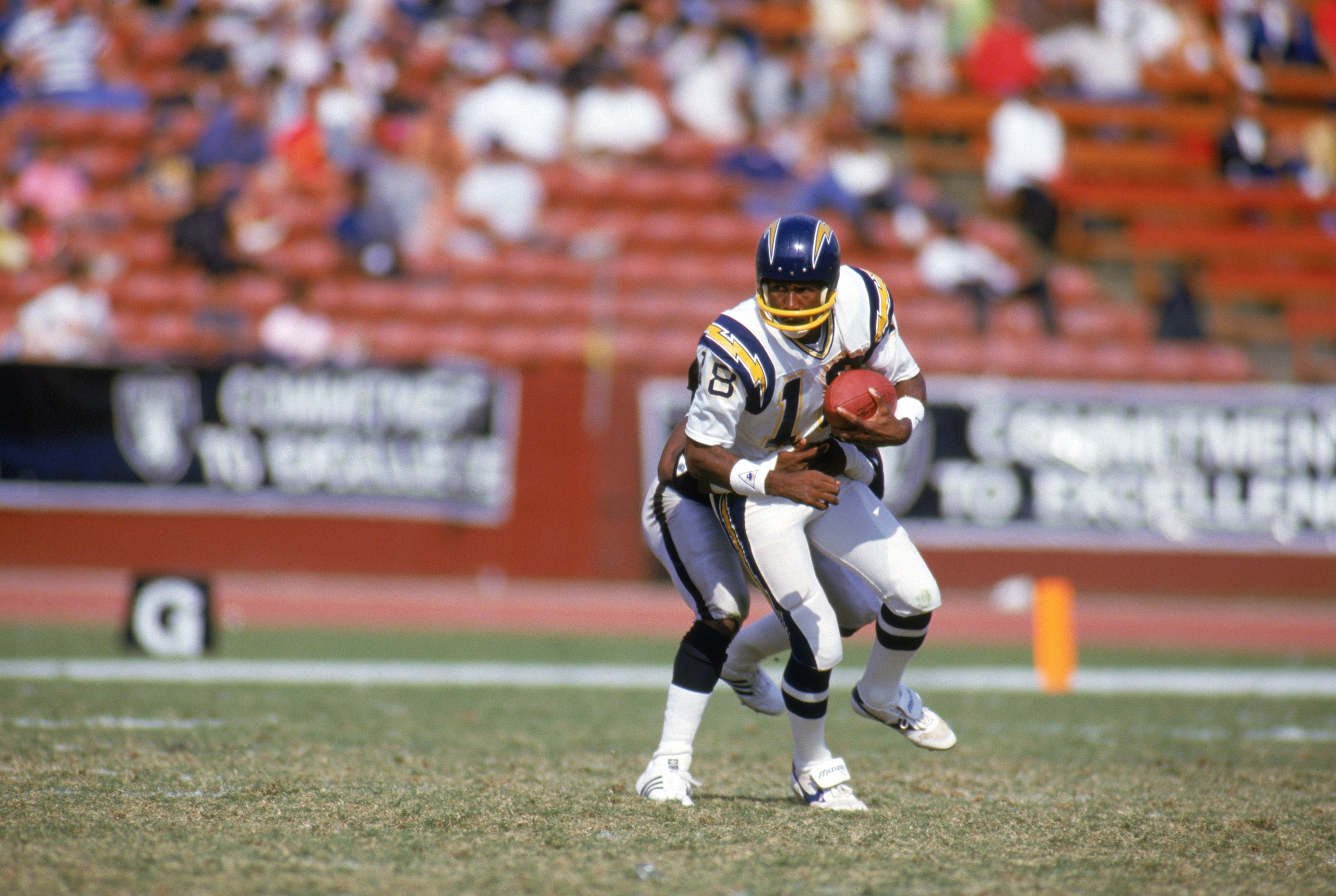 LOS ANGELES - 1985:  Wide receiver Charlie Joiner #18 of the San Diego Chargers tries to break away from a tackle during a game against the Los Angeles Raiders in 1985 at Los Angeles Memorial Coliseum in Los Angeles, California.  (Photo by Rick Stewart/Ge