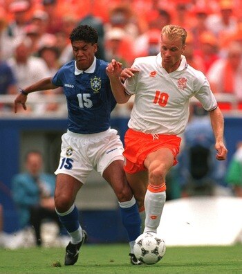 9 Jul 1994: DENNIS BERGKAMP OF HOLLAND IS CHALLENGED BY MARCIO SANTOS OF BRAZIL DURING THE 1994 WORLD CUP FINALS QUARTER FINAL MATCH AT THE COTTON BOWL STADIUM IN DALLAS TEXAS.