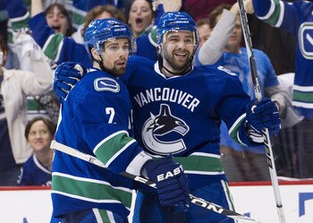 VANCOUVER, CANADA - APRIL 28: Chris Higgins #20 (R) celebrates with Dan Hamhuis #2 of the Vancouver Canucks after scoring against the Nashville Predators during the second period in Game One of the Western Conference Semifinals during the 2011 NHL Stanley VANCOUVER, CANADA - APRIL 28: Chris Higgins #20 (R) celebrates with Dan Hamhuis #2 of the Vancouver Canucks after scoring against the Nashville Predators during the second period in Game One of the Western Conference Semifinals during the 2011 NHL Stanley