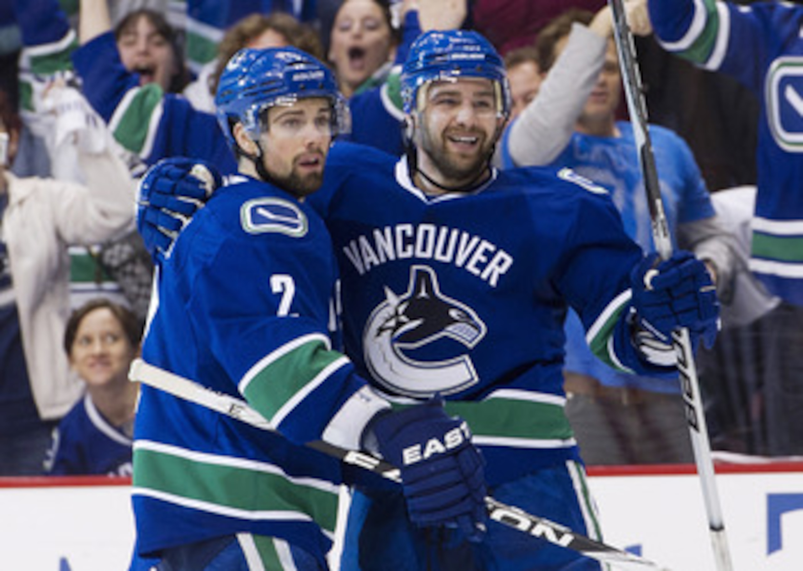 VANCOUVER, CANADA - APRIL 28: Chris Higgins #20 (R) celebrates with Dan Hamhuis #2 of the Vancouver Canucks after scoring against the Nashville Predators during the second period in Game One of the Western Conference Semifinals during the 2011 NHL Stanley