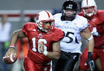 RALEIGH, NC - SEPTEMBER 16:  Derek Wolfe #95 of the Cincinnati Bearcats tries to chase down Russell Wilson #16 of the North Carolina State Wolfpack during their game at Carter-Finley Stadium on September 16, 2010 in Raleigh, North Carolina.  (Photo by Str