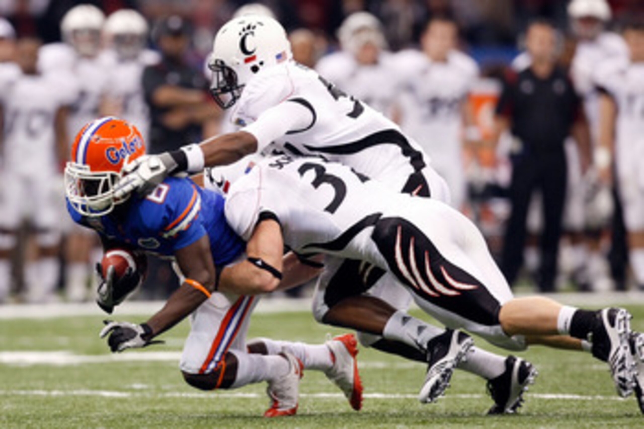 NEW ORLEANS - JANUARY 01:  Deonte Thompson #6 of the Florida Gators gets tackled by J.K. Schaffer #37 of the Cincinnati Bearcats during the Allstate Sugar Bowl at the Louisana Superdome on January 1, 2010 in New Orleans, Louisiana.  (Photo by Kevin C. Cox