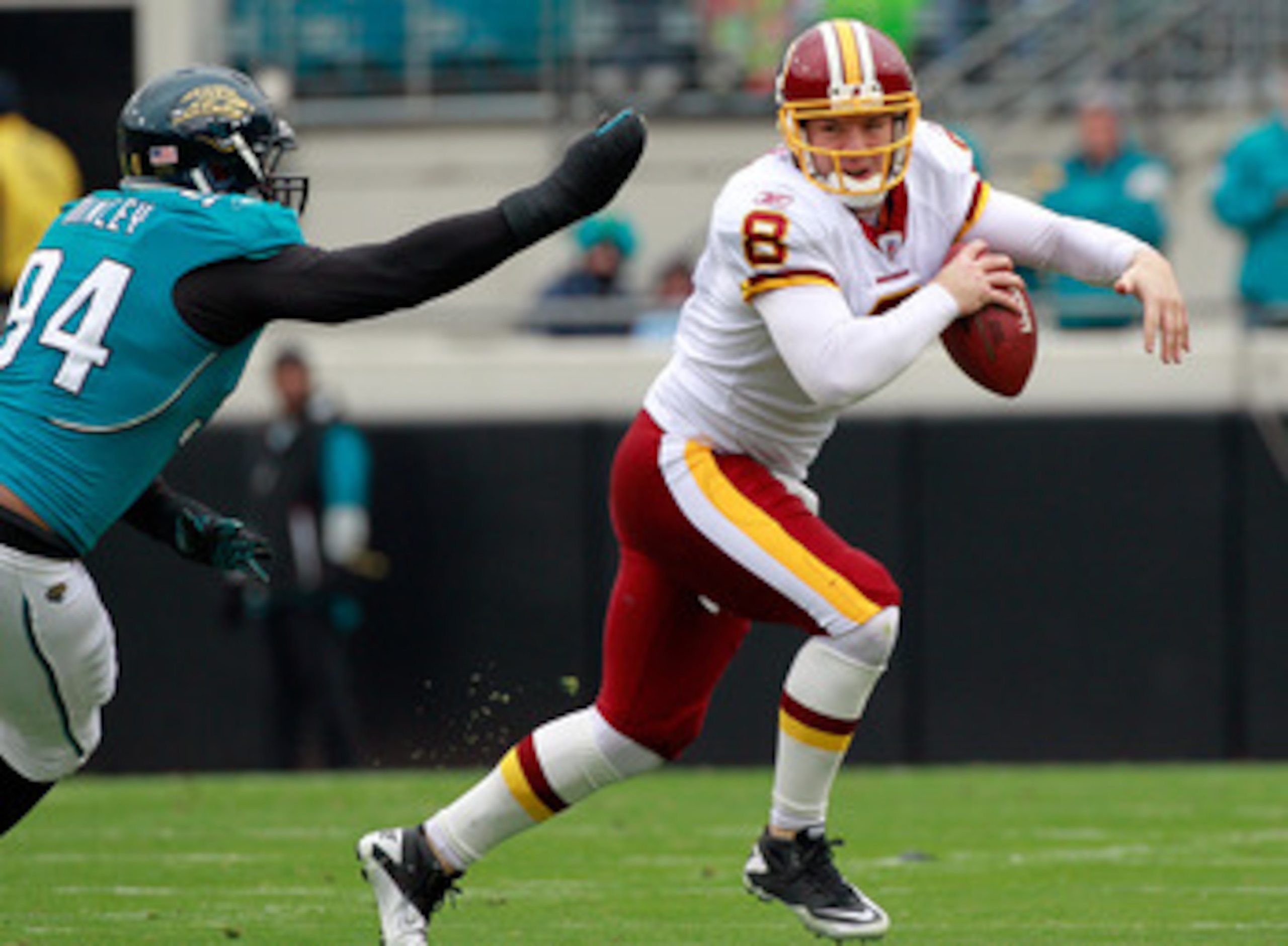 JACKSONVILLE, FL - DECEMBER 26: Quarterback Rex Grossman #8 of the Washington Redskins is pressured by Jeremy Mincey #94 of the Jacksonville Jaguars during the game at EverBank Field on December 26, 2010 in Jacksonville, Florida.  (Photo by Sam Greenwood/