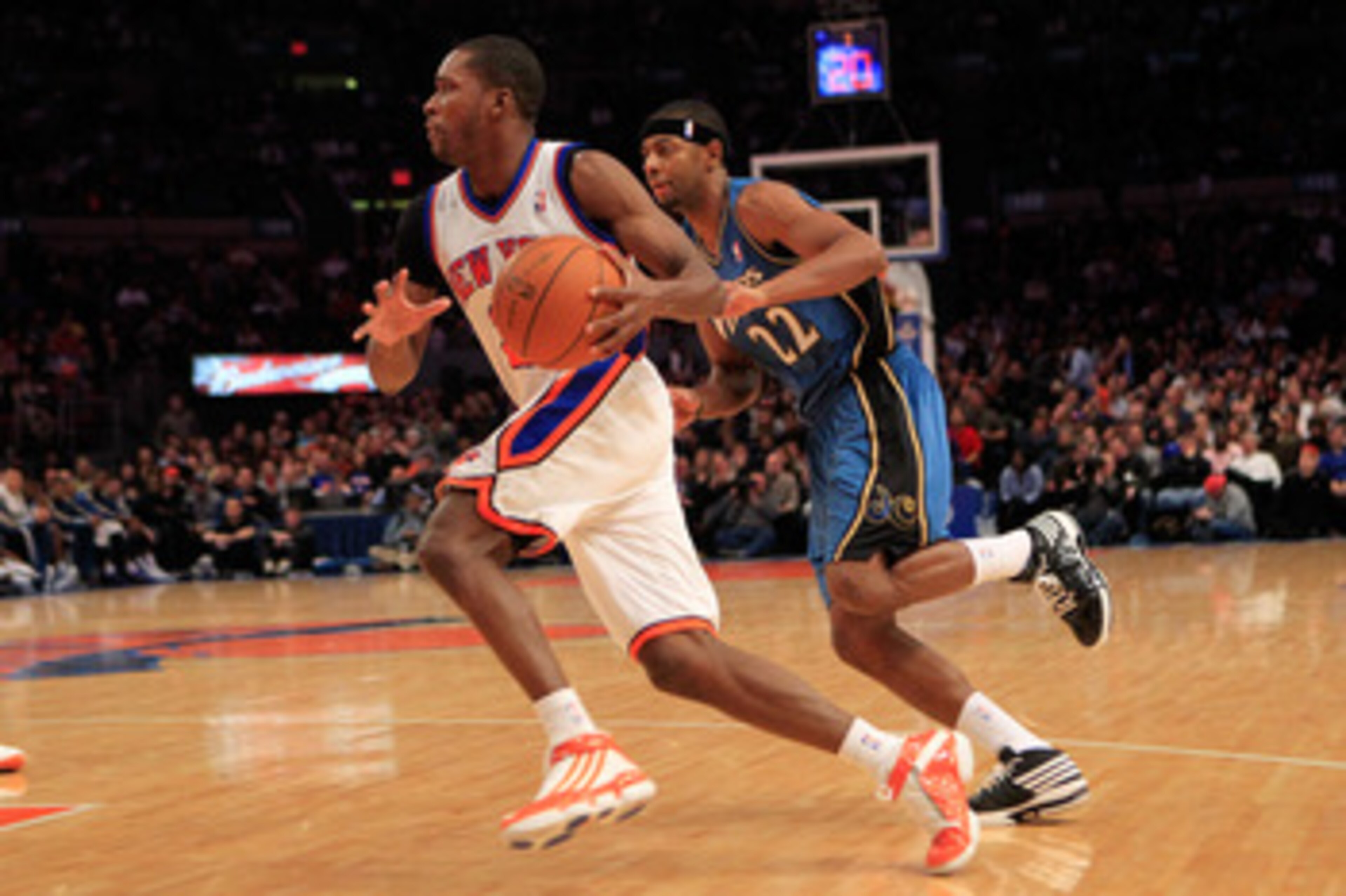 NEW YORK, NY - JANUARY 24: Toney Douglas #23 of the New York Knicks drives past Mustafa Shakur #22 of the Washington Wizards at Madison Square Garden on January 24, 2011 in New York City. NOTE TO USER: User expressly acknowledges and agrees that, by downl