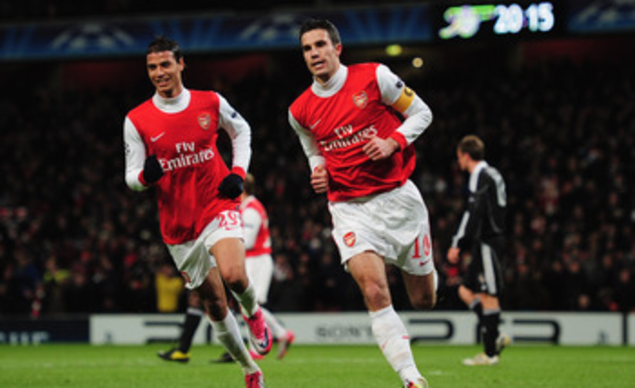 LONDON, ENGLAND - DECEMBER 08:  Robin van Persie of Arsenal celebrates with Marouane Chamakh (L) as he scores their first goal from the penalty spot during the UEFA Champions League Group H match between Arsenal and FK Partizan Belgrade at the Emirates St