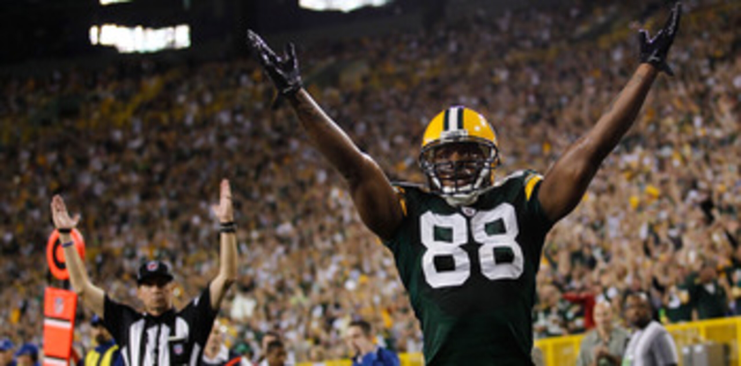 GREEN BAY, WI - AUGUST 26: Jermichael Finley #88 of the Green Bay Packers signals, along with a referee, a touchdown against the Indianapolis Colts during a preseason game at Lambeau Field on August 26, 2010 in Green Bay, Wisconsin. (Photo by Jonathan Dan