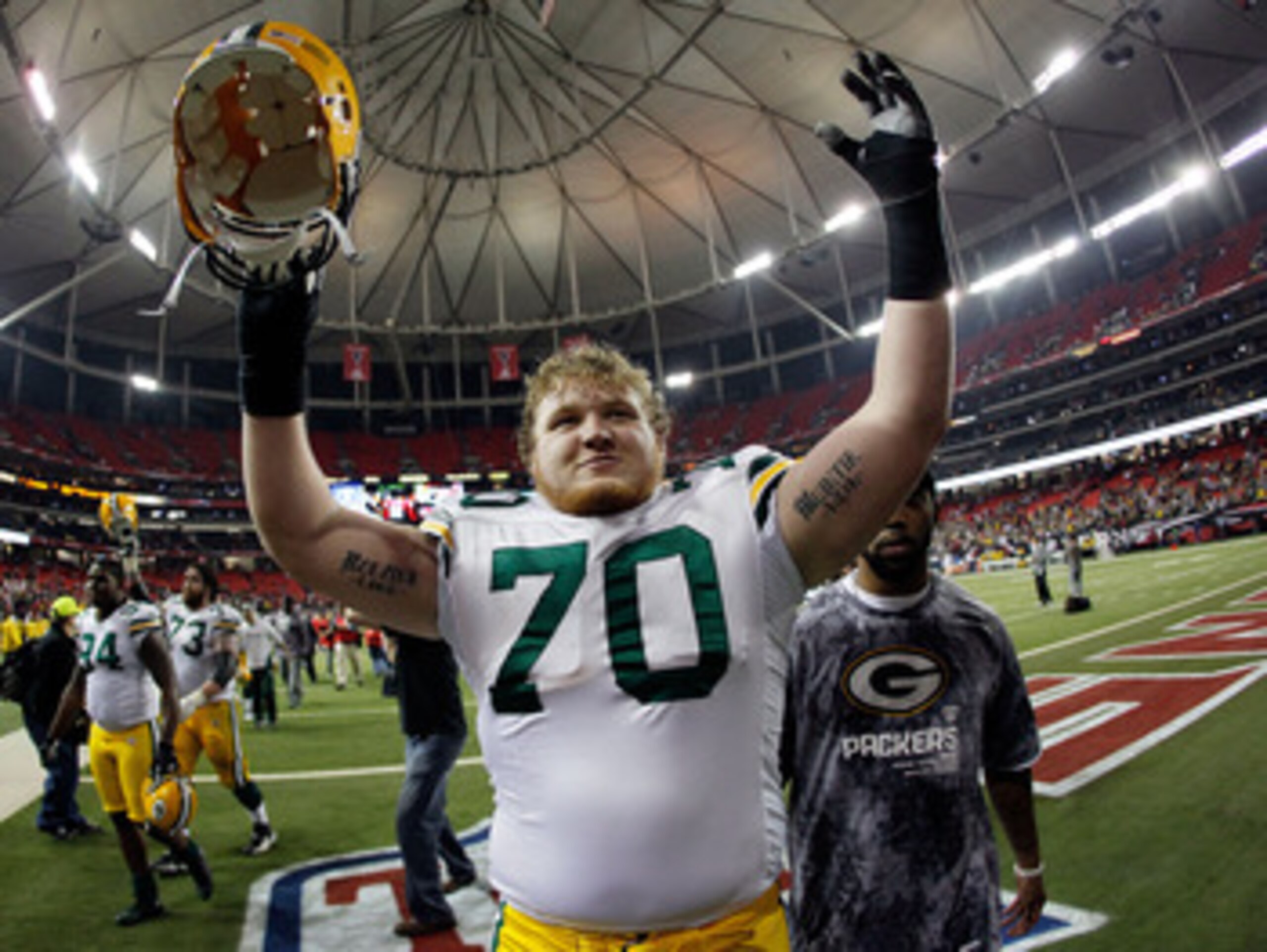 ATLANTA, GA - JANUARY 15:  Tackle T.J. Lang #70 of the Green Bay Packers celebrates as he walks off the field after the Packers won 48-21 against the Atlanta Falcons during their 2011 NFC divisional playoff game at Georgia Dome on January 15, 2011 in Atla