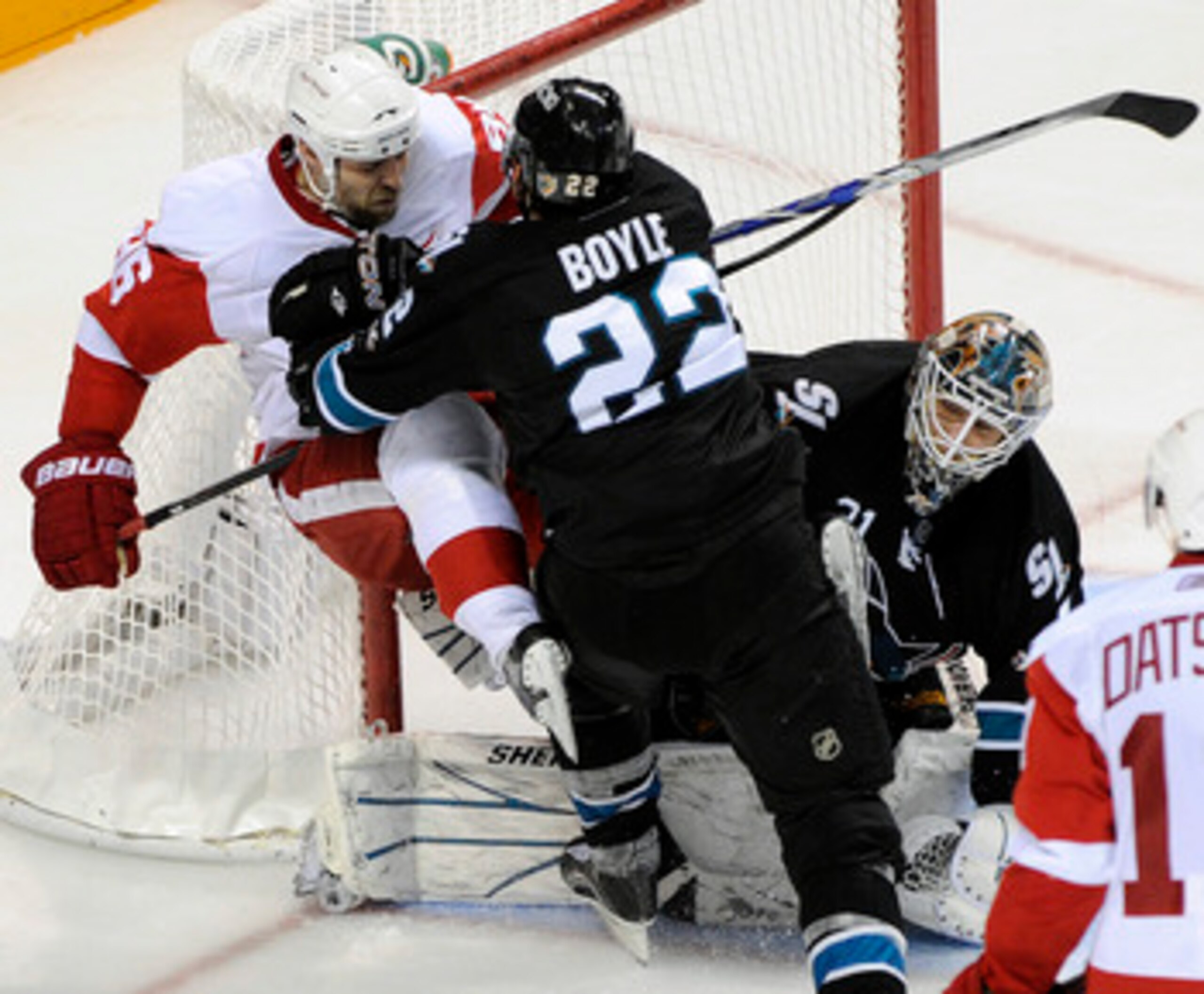 SAN JOSE, CA - MAY 12: Dan Boyle #22 of the San Jose Sharks check into the pole of the goal Tomas Holmstrom #96 of the Detroit Red Wings in Game Seven of the Western Conference Semifinals  during the 2011 NHL Stanley Cup Playoffs at the HP Pavilion on May