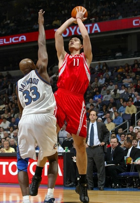 WASHINGTON - JANUARY 13:  Yao Ming #11 of the Houston Rockets shoots over Brendan Haywood #33 of the Washington Wizards during NBA action at the MCI Center on January 13, 2004 in Washington, DC.  NOTE TO USER: User expressly acknowledges and agrees that b