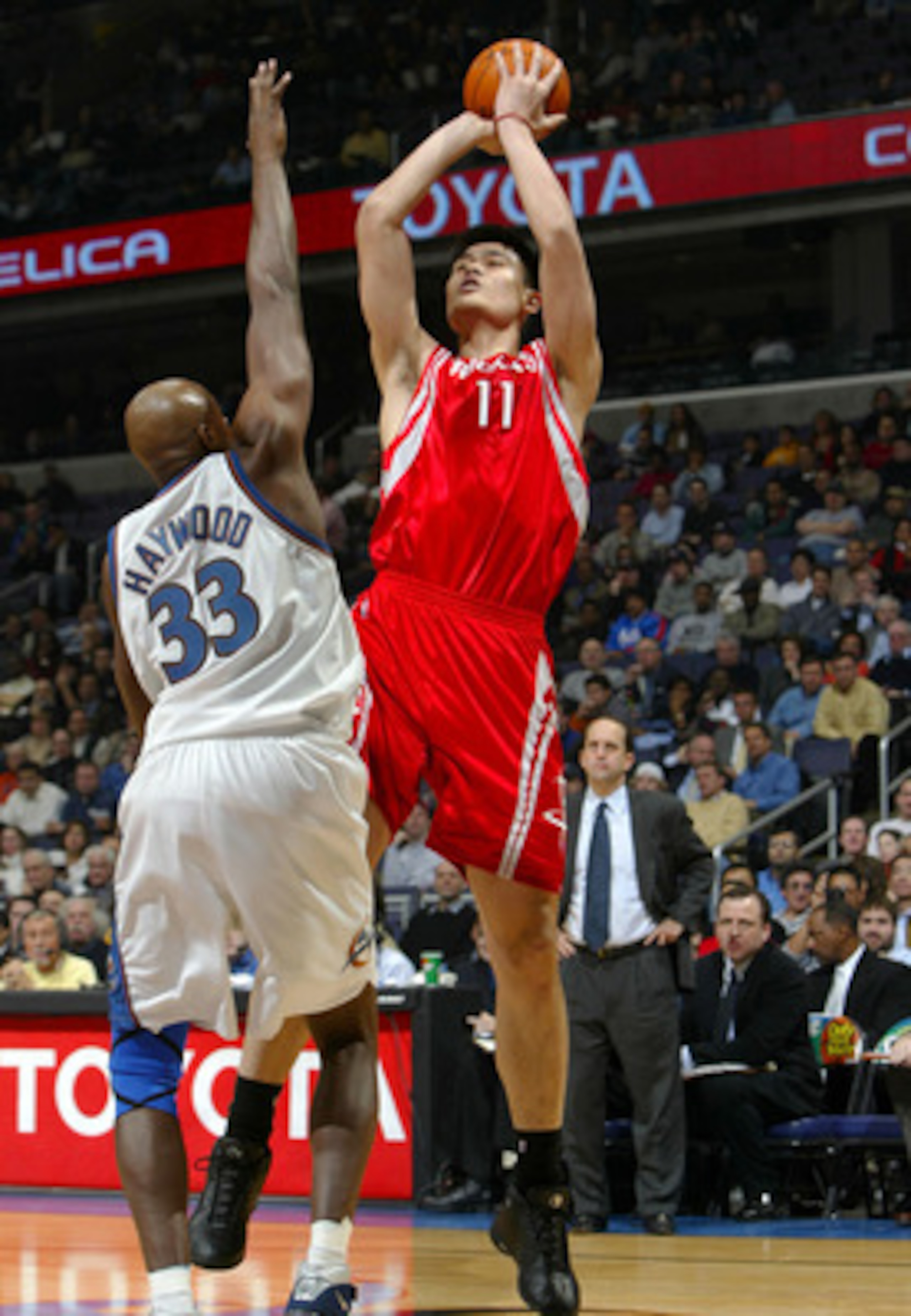 WASHINGTON - JANUARY 13:  Yao Ming #11 of the Houston Rockets shoots over Brendan Haywood #33 of the Washington Wizards during NBA action at the MCI Center on January 13, 2004 in Washington, DC.  NOTE TO USER: User expressly acknowledges and agrees that b