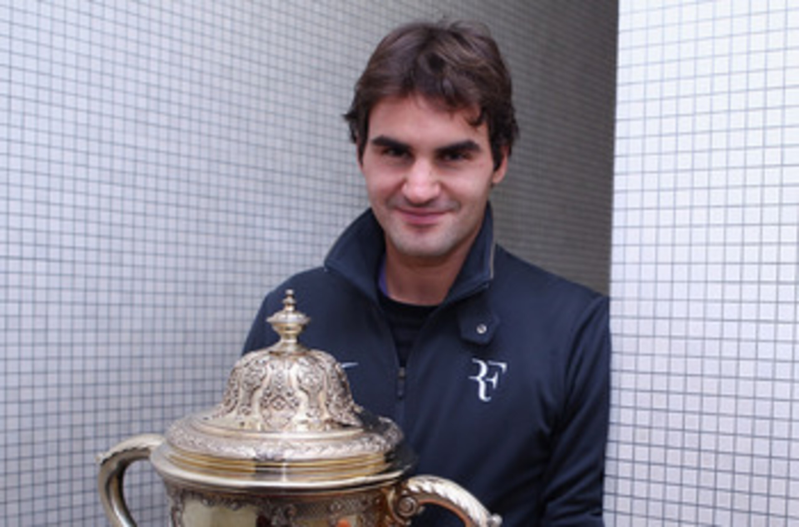 BASEL, SWITZERLAND - NOVEMBER 07:  Roger Federer of Switzerland poses for a photo with the trophy after defeating Novak Djokovic of Serbia in the final during Day Seven of the Davidoff Swiss Indoors Tennis at St Jakobshalle on November 7, 2010 in Basel, S