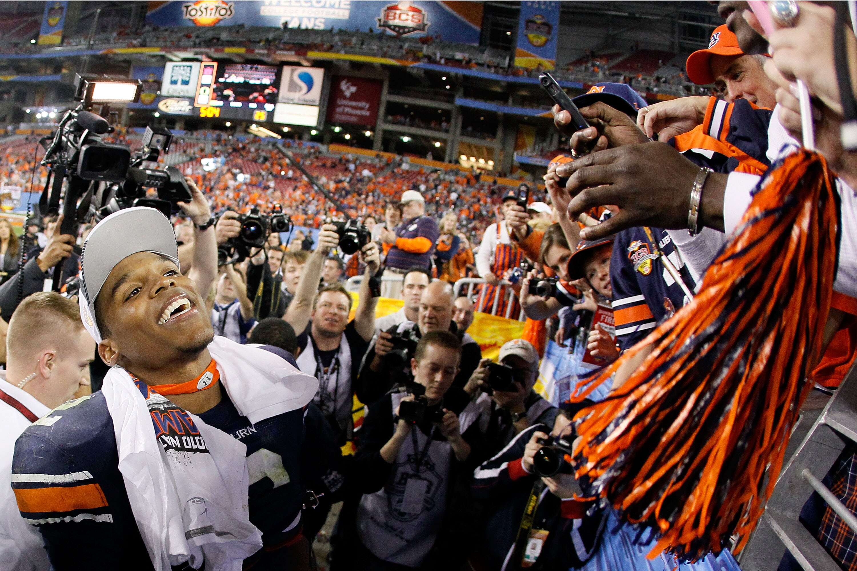 GLENDALE, AZ - JANUARY 10: Quarterback Cameron Newton #2 of the Auburn Tigers celebrates their 22-19 victory after defeating the Oregon Ducks in the Tostitos BCS National Championship Game at University of Phoenix Stadium on January 10, 2011 in Glendale, GLENDALE, AZ - JANUARY 10: Quarterback Cameron Newton #2 of the Auburn Tigers celebrates their 22-19 victory after defeating the Oregon Ducks in the Tostitos BCS National Championship Game at University of Phoenix Stadium on January 10, 2011 in Glendale,