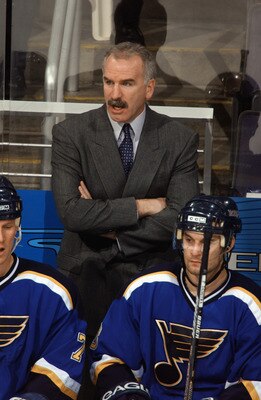 WASHINGTON - JANUARY 28:  Head coach Joel Quenneville of the St. Louis Blues watches the game against the Washington Capitals at the MCI Center on January 28, 2003 in Washington, DC. The Blues defeated the Capitals 5-3. (Photo by Mitchell Layton/Getty Ima