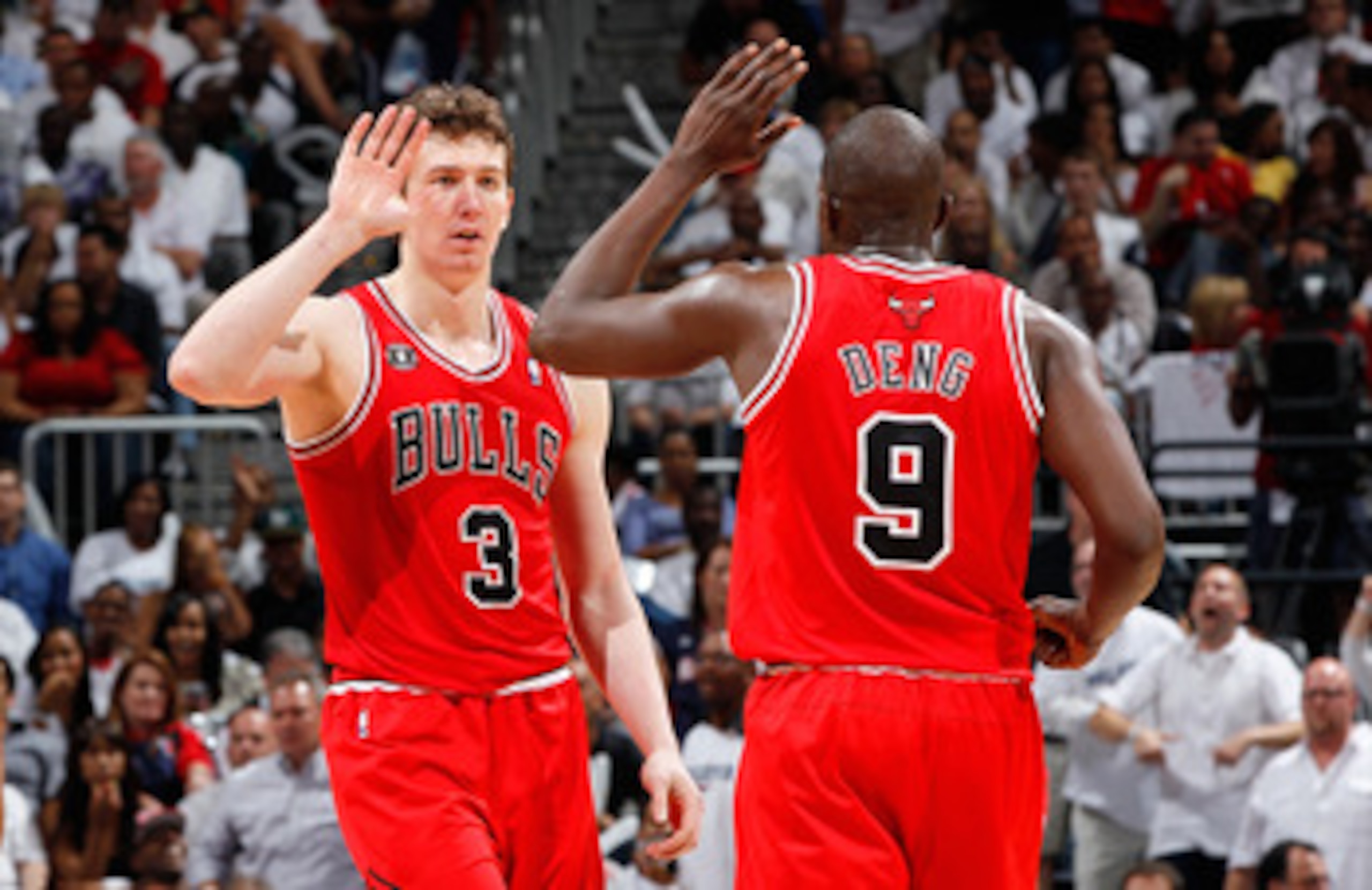 ATLANTA, GA - MAY 12:  Omer Asik #3 reacts with Luol Deng #9 of the Chicago Bulls after Asik drew a foul from the Atlanta Hawks in Game Six of the Eastern Conference Semifinals in the 2011 NBA Playoffs at Phillips Arena on May 12, 2011 in Atlanta, Georgia