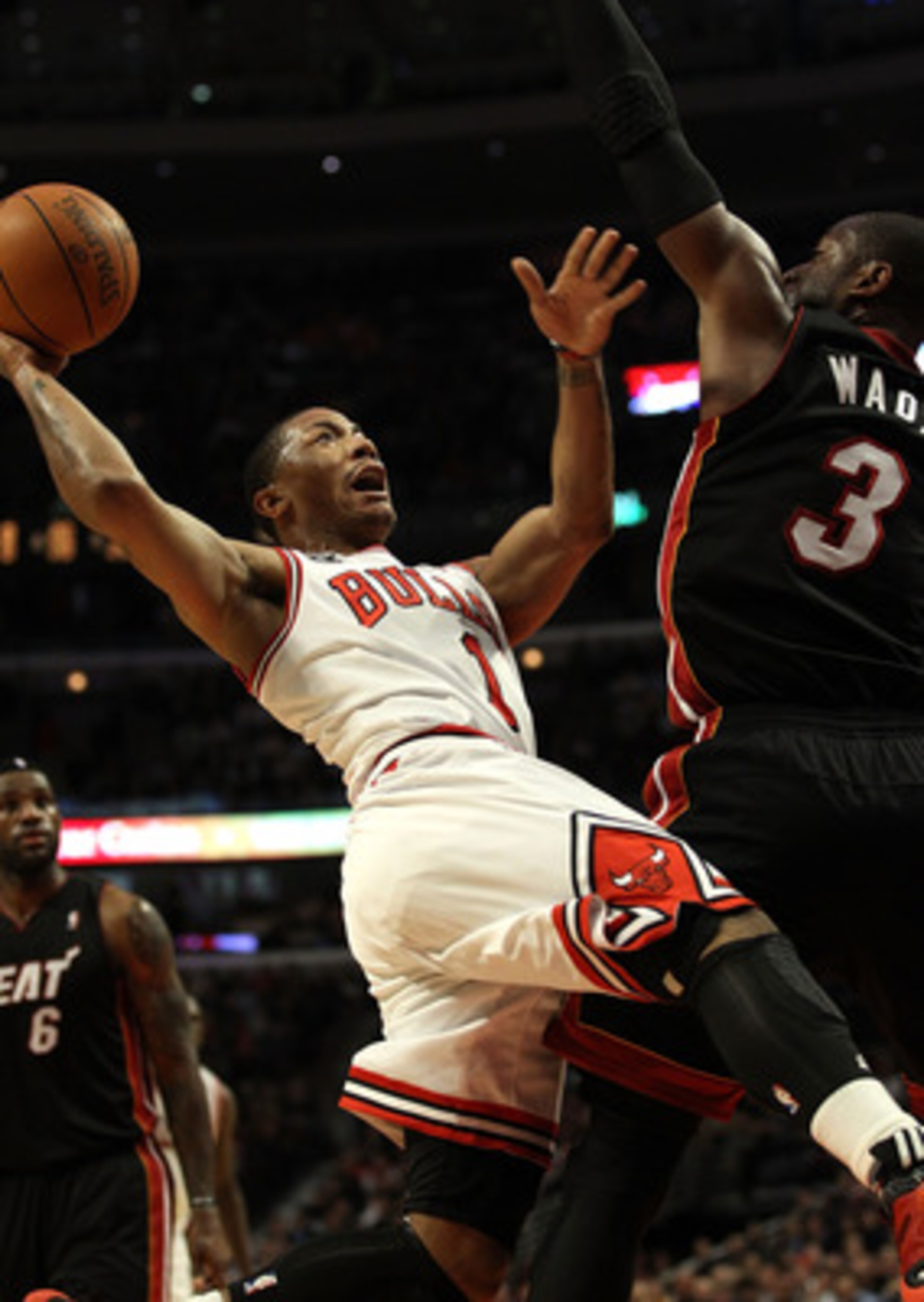 CHICAGO, IL - FEBRUARY 24: Derrick Rose #1 of the Chicago Bulls puts up a shot against Dwyane Wade #3 of the Miami Heat at the United Center on February 24, 2011 in Chicago, Illinois. The Bulls defeated the Heat 93-89. NOTE TO USER: User expressly acknowl