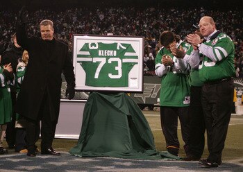 EAST RUTHERFORD, NJ - DECEMBER 26:  Former player Joe Klecko (left) of the New York Jets gets his jersey retired during halftime against the New England Patriots on December 26, 2004 at Giants Stadium in East Rutherford, New Jersey.  The Patriots won the 