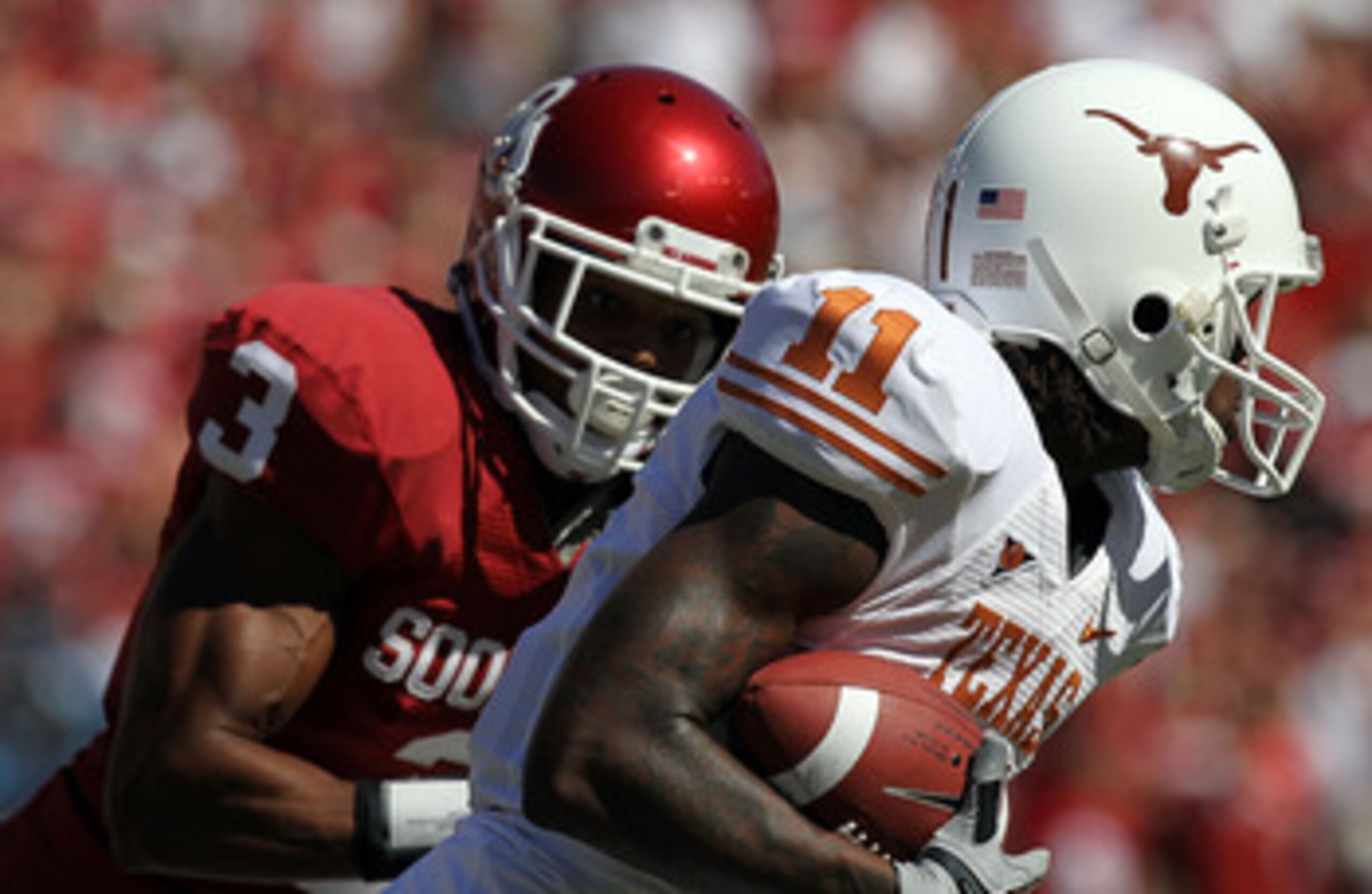 DALLAS - OCTOBER 02:  Wide receiver James Kirkendoll #11 of the Texas Longhorns runs past Jonathan Nelson #3 of the Oklahoma Sooners in the first quarter at the Cotton Bowl on October 2, 2010 in Dallas, Texas.  (Photo by Ronald Martinez/Getty Images)