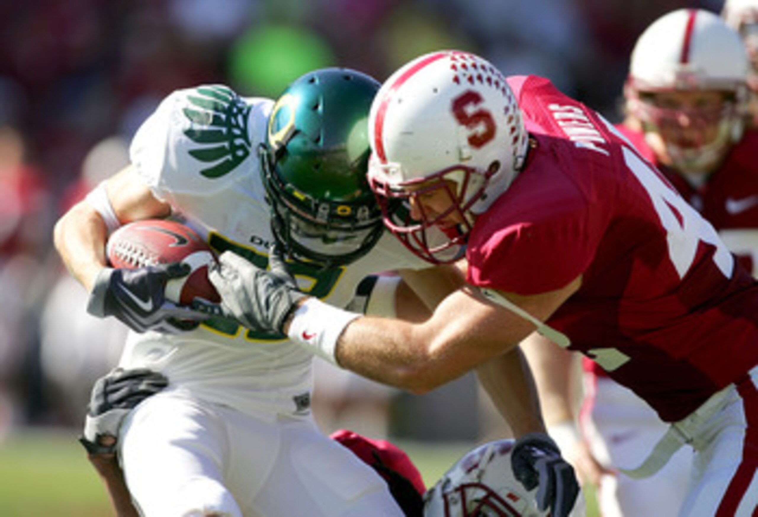 PALO ALTO, CA - NOVEMBER 07:  Jeff Maehl #23 of the Oregon Ducks is tackled by Will Powers #42 of the Stanford Cardinal at Stanford Stadium on November 7, 2009 in Palo Alto, California.  (Photo by Ezra Shaw/Getty Images)