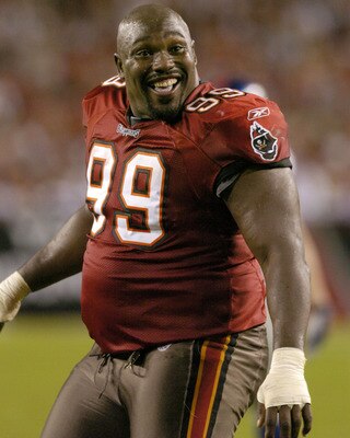 Tampa Bay Buccaneers defensive tackle Warren Sapp plays to the crowd after losing  his helmet while rushing  November 24, 2003 against the New York Giants  at Raymond James Stadium, Tampa.  (Photo by Al Messerschmidt/Getty Images)