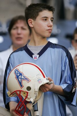 HOUSTON - NOVEMBER 28:  A Houston Texans fan holds an old Houston Oilers helmet at the game against the Tenessee Titans on November 28, 2004 at Reliant Stadium in Houston, Texas. The Texans defeated the Titans 31-21. (Photo by Ronald Martinez/Getty Images
