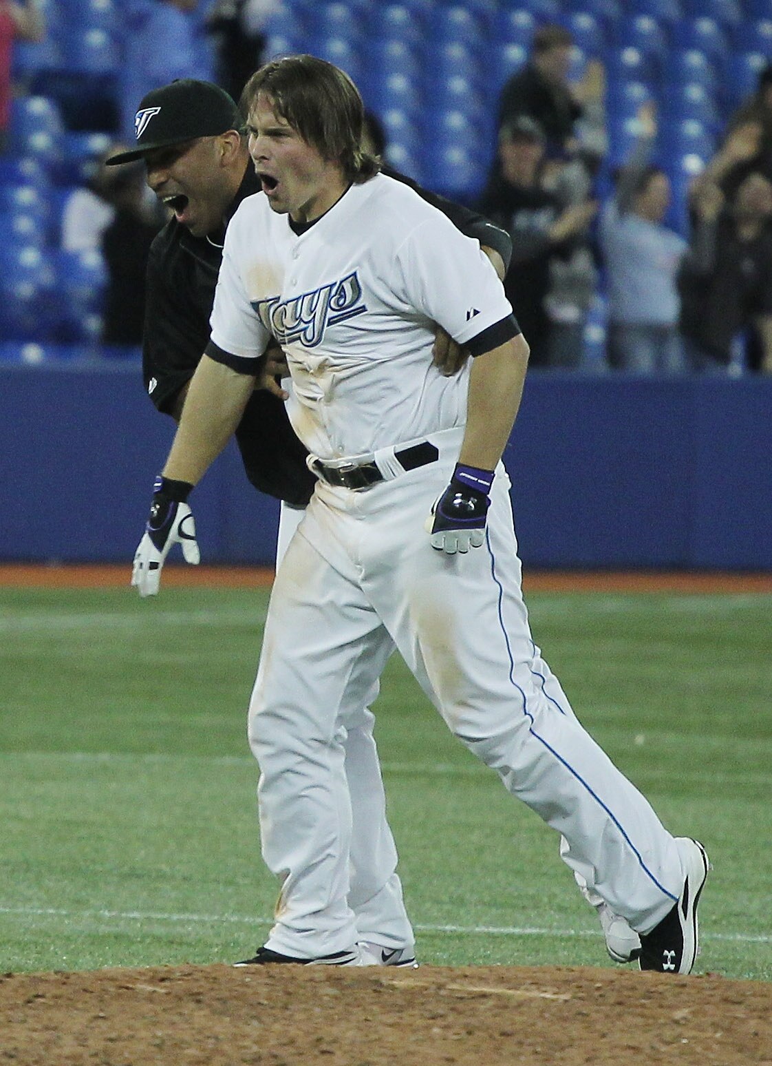TORONTO, ON - APRIL 19:  Travis Snider #45 (R) and Ricky Romero #24 of the Toronto Blue Jays celebrate after Snider drove in the winning run in the tenth inning to defeat New York Yankees 6-5 at Rogers Centre on April 19, 2011 in Toronto, Canada. (Photo b