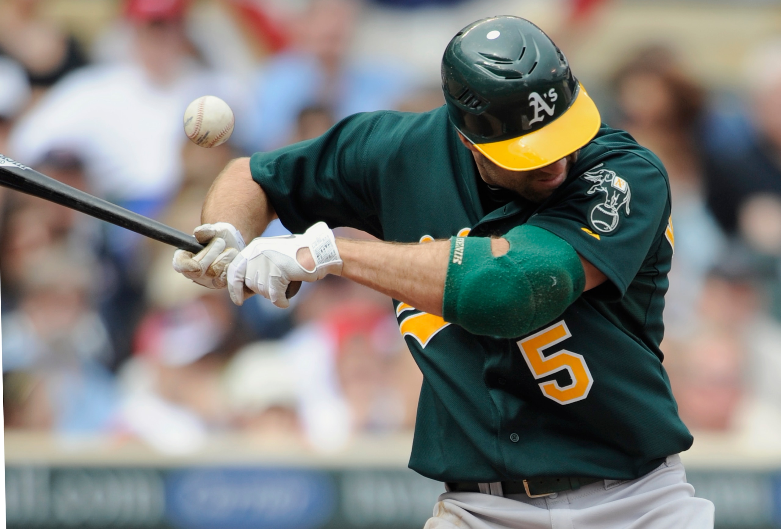 MINNEAPOLIS, MN - APRIL 10: Kevin Kouzmanoff #5 of the Oakland Athletics gets hit by a pitch thrown by relief pitcher Alex Burnett #31 of the Minnesota Twins during the eighth inning of their game on April 10, 2011 at Target Field in Minneapolis, Minnesot