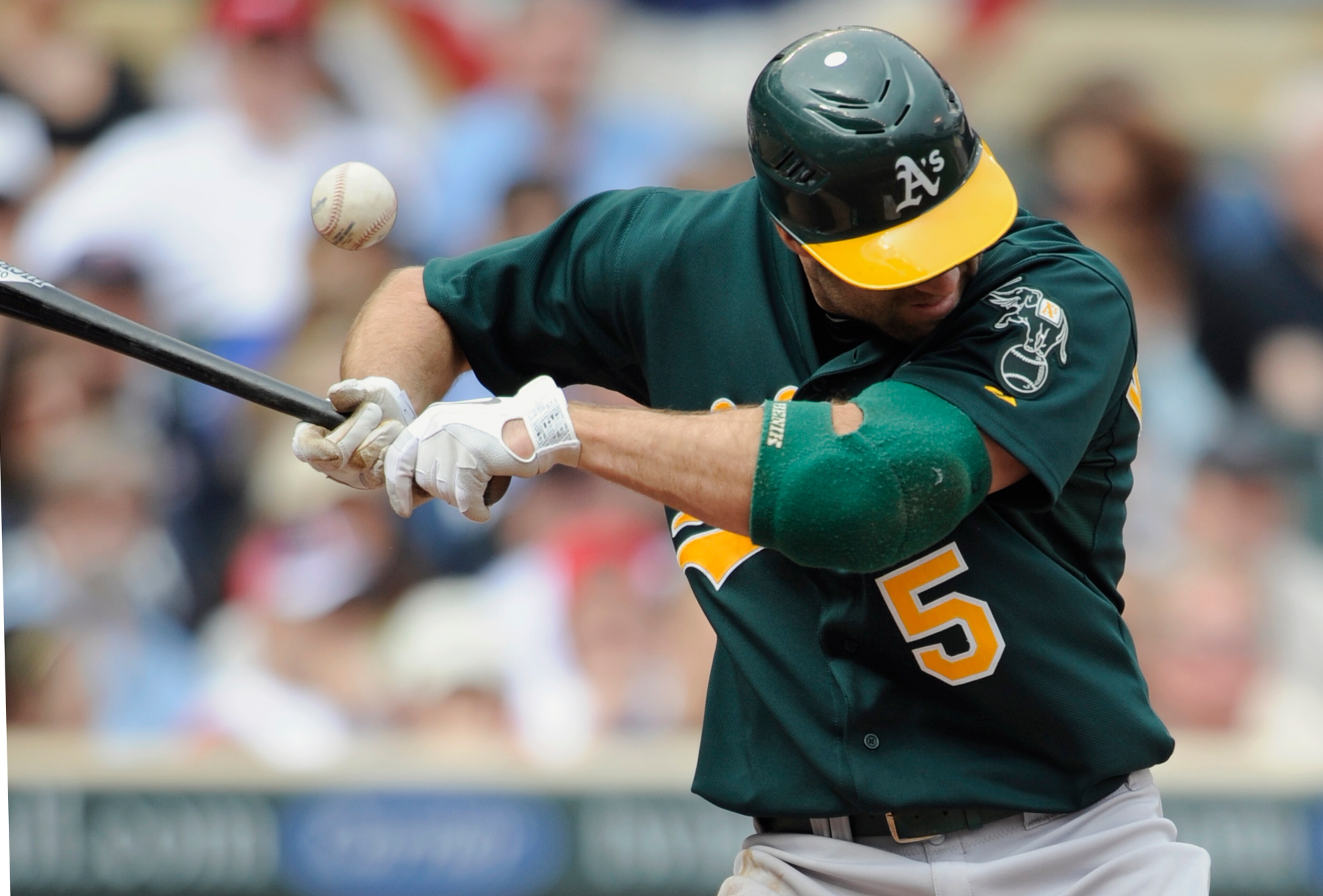 MINNEAPOLIS, MN - APRIL 10: Kevin Kouzmanoff #5 of the Oakland Athletics gets hit by a pitch thrown by relief pitcher Alex Burnett #31 of the Minnesota Twins during the eighth inning of their game on April 10, 2011 at Target Field in Minneapolis, Minnesot