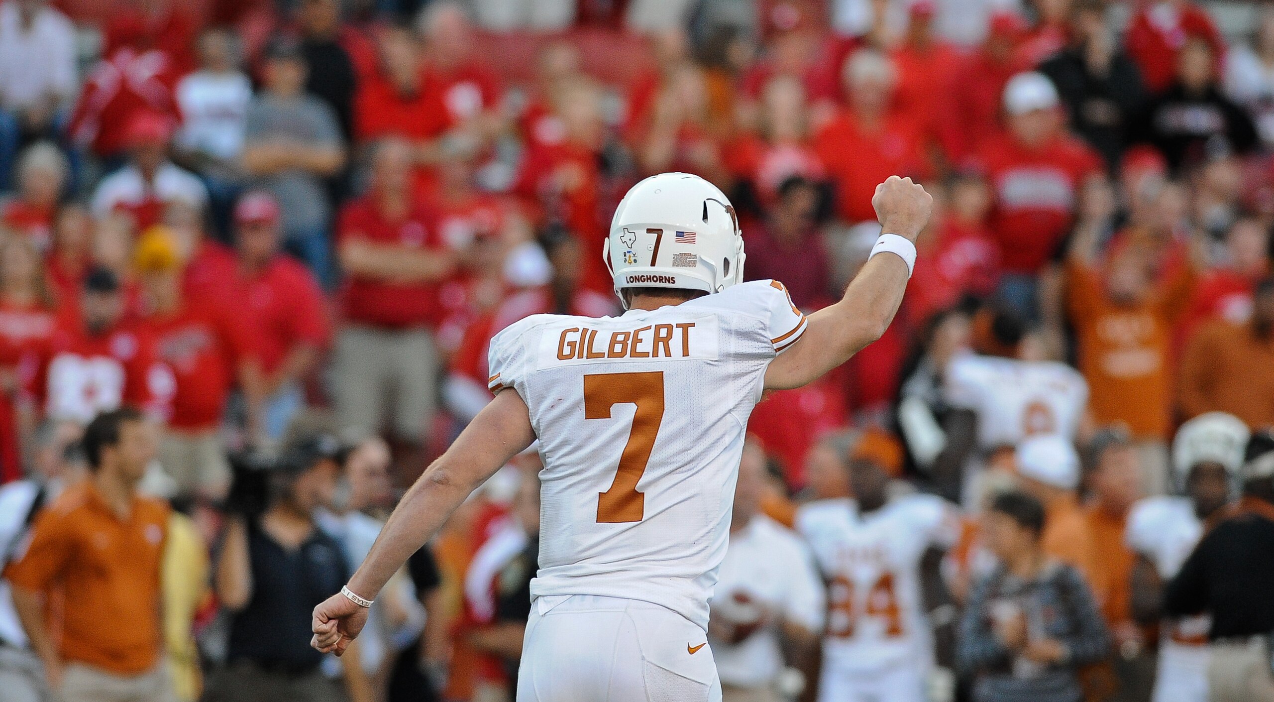 LINCOLN, NE - OCTOBER 16: Quarterback Garrett Gilbert #7 of the Texas Longhorns runs toward his teammates ofter the final of their game against the Nebraska Cornhuskers at Memorial Stadium on October 16, 2010 in Lincoln, Nebraska. Texas Defeated Nebraska 