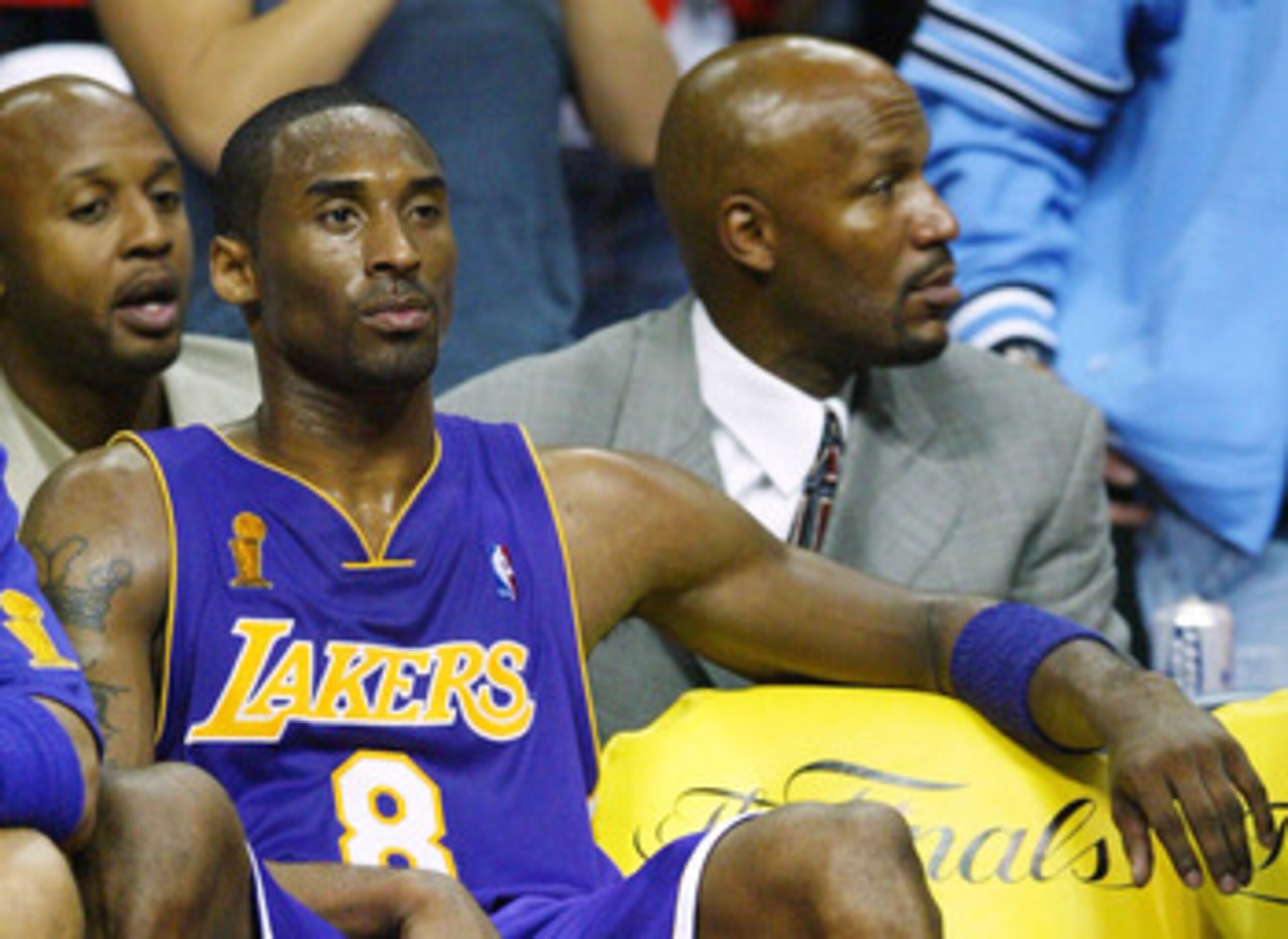 AUBURN HILLS, MI - JUNE 10:  Kobe Bryant #8 of the Los Angeles Lakers sits on the bench in front of former Lakers Brian Shaw (back-L) and Ron Harper (back-R) during a time-out in the fourth quarter of game three of the 2004 NBA Finals against the Detroit