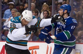 VANCOUVER, CANADA - JANUARY 20: Ryan Kesler #17 of the Vancouver Canucks and Derek Joslin #65 of the San Jose Sharks push and shove behind the play during the second period in NHL action on January 20, 2011 at Rogers Arena in Vancouver, BC, Canada.  (Phot