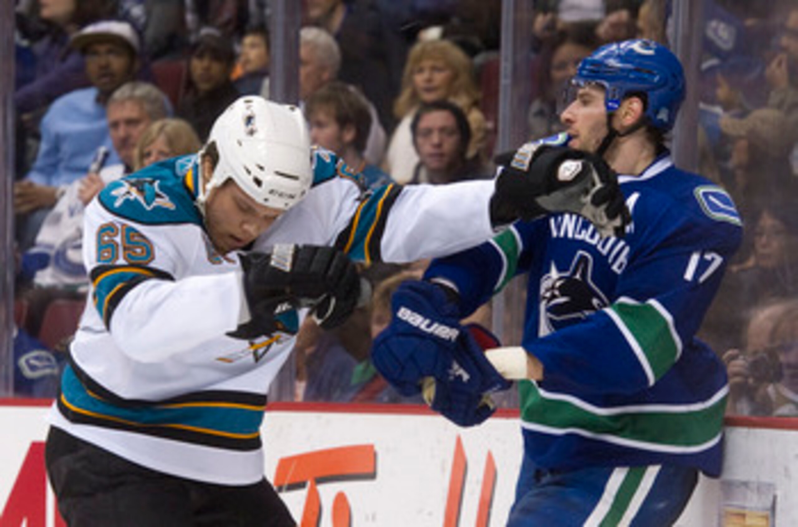 VANCOUVER, CANADA - JANUARY 20: Ryan Kesler #17 of the Vancouver Canucks and Derek Joslin #65 of the San Jose Sharks push and shove behind the play during the second period in NHL action on January 20, 2011 at Rogers Arena in Vancouver, BC, Canada.  (Phot