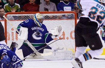 VANCOUVER, CANADA - JANUARY 20: Goalie Roberto Luongo #1 of the Vancouver Canucks makes a glove save on Dan Boyle #22 of the San Jose Sharks during the second period in NHL action on January 20, 2011 at Rogers Arena in Vancouver, BC, Canada.  (Photo by Ri