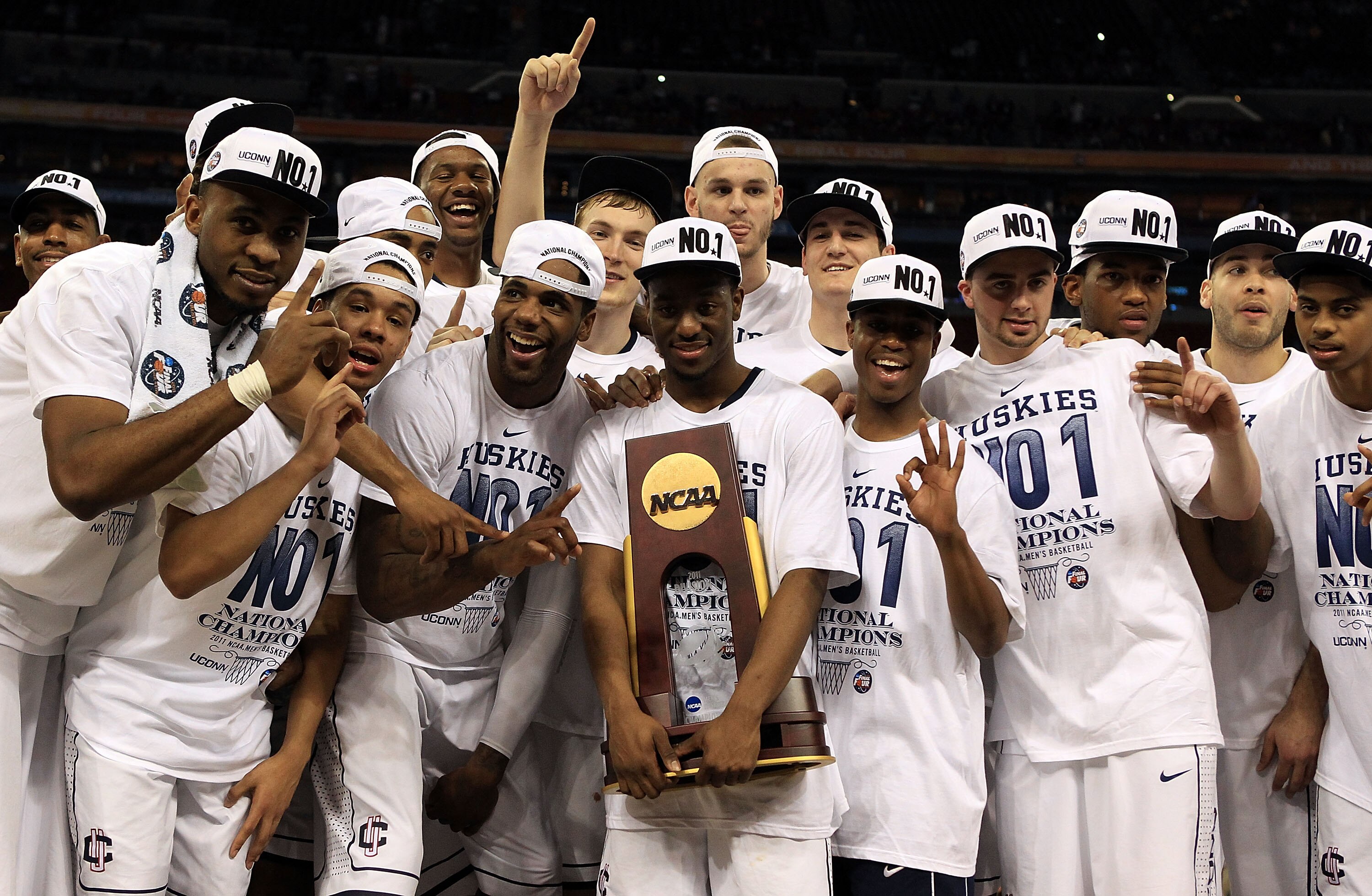 HOUSTON, TX - APRIL 04:  Kemba Walker #15 of the Connecticut Huskies holds the trophy as he and his team celebrate after defeating the Butler Bulldogs to win the National Championship Game of the 2011 NCAA Division I Men's Basketball Tournament by a score