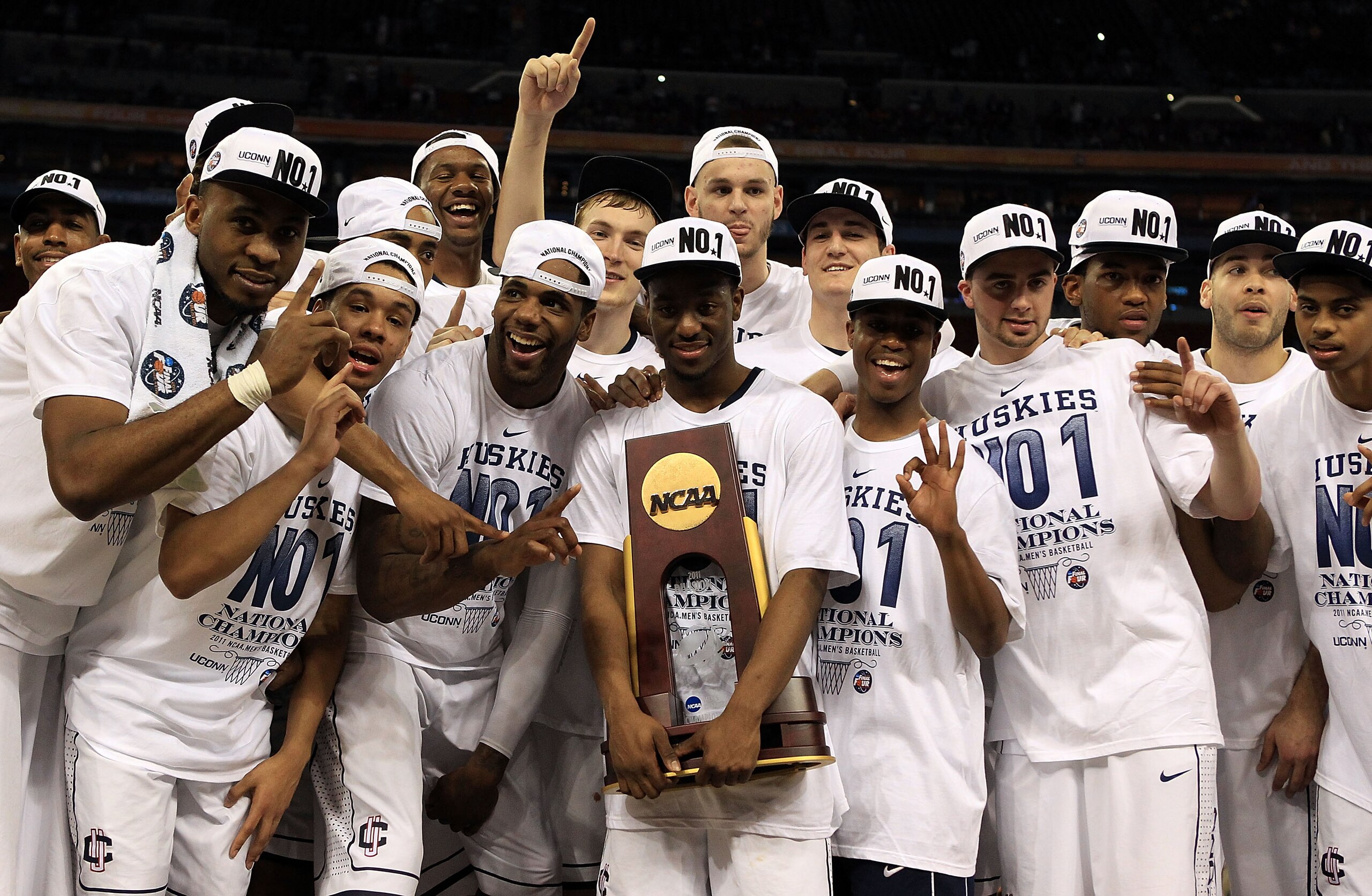 HOUSTON, TX - APRIL 04:  Kemba Walker #15 of the Connecticut Huskies holds the trophy as he and his team celebrate after defeating the Butler Bulldogs to win the National Championship Game of the 2011 NCAA Division I Men's Basketball Tournament by a score