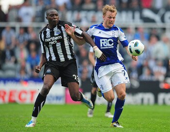 NEWCASTLE UPON TYNE, ENGLAND - MAY 07:  Birmingham player Sebastian Larsson (r) battles with Shola Ameobi during the Barclays Premier League game between Newcastle United and Birmingham City at St James' Park on May 7, 2011 in Newcastle upon Tyne, England