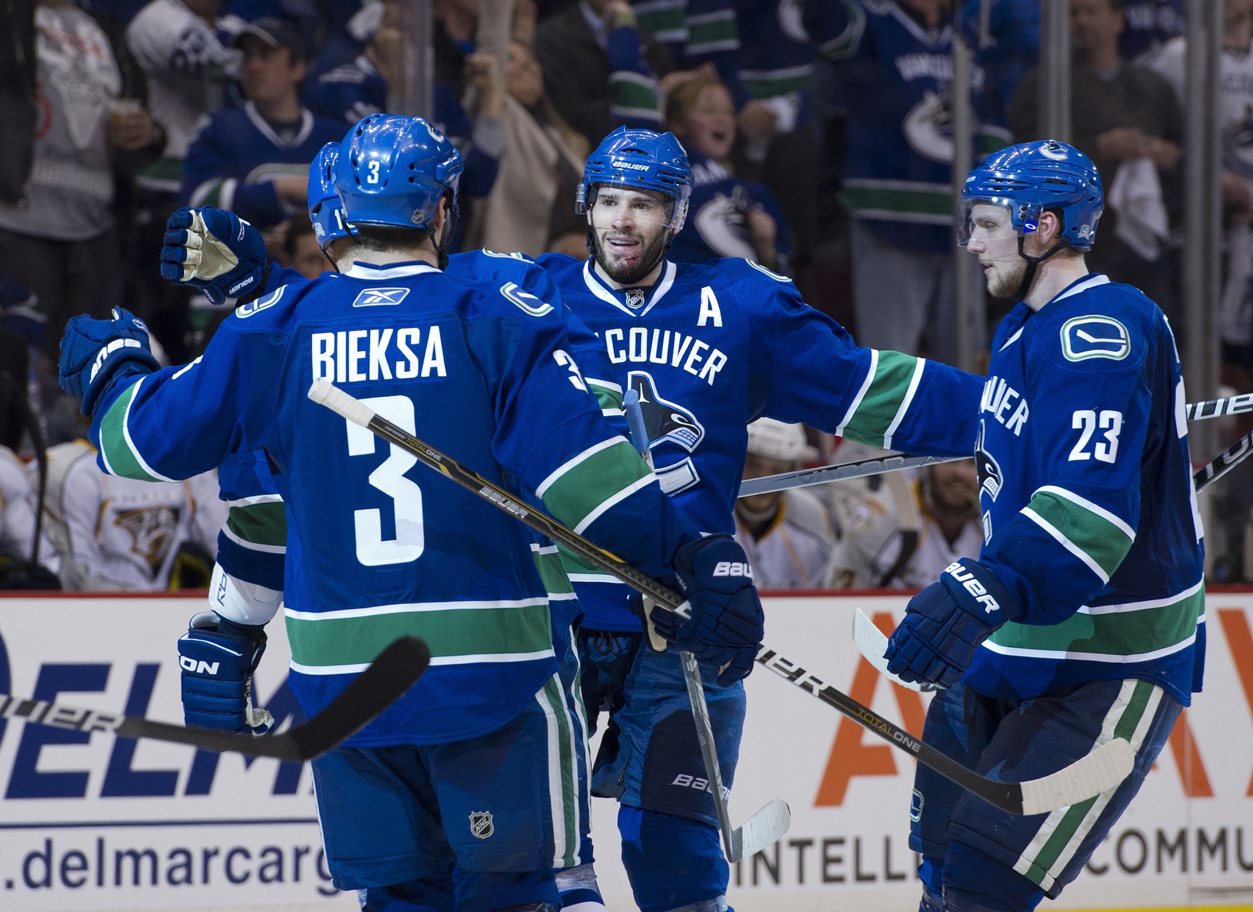 VANCOUVER, CANADA - MAY 7: Ryan Kesler #17 of the Vancouver Canucks celebrates with Kevin Bieksa #3 and Alexander Edler #23 of the Vancouver Canucks after scoring against the Nashville Predators during the third period in Game Five of the Western Conferen