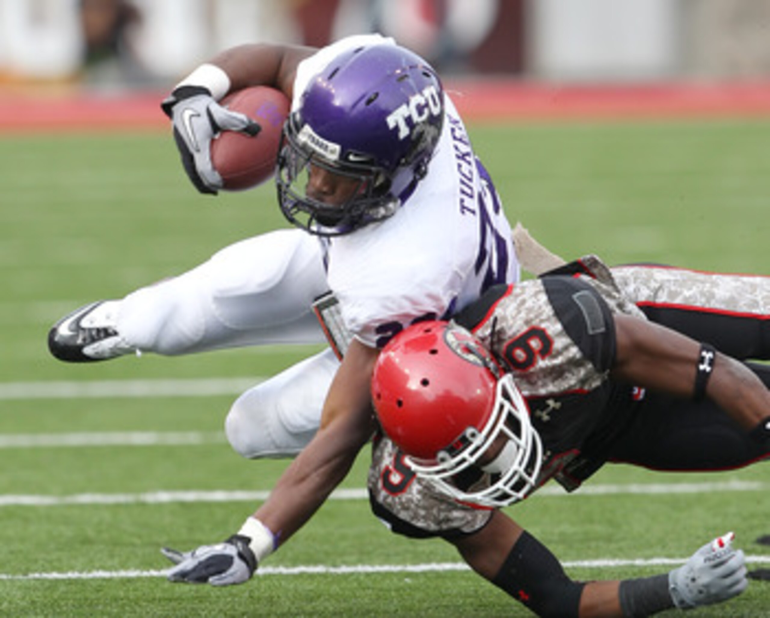 SALT LAKE CITY, UT - NOVEMBER 6: Conroy Black #9 of the Utah Utes tackles Matthew Tucker #29 of the TCU Horned Frogs during the second half of an NCAA Football game November 6, 2010 at Rice-Eccles Stadium in Salt Lake City, Utah. TCU Beat Utah 47-7.  (Pho