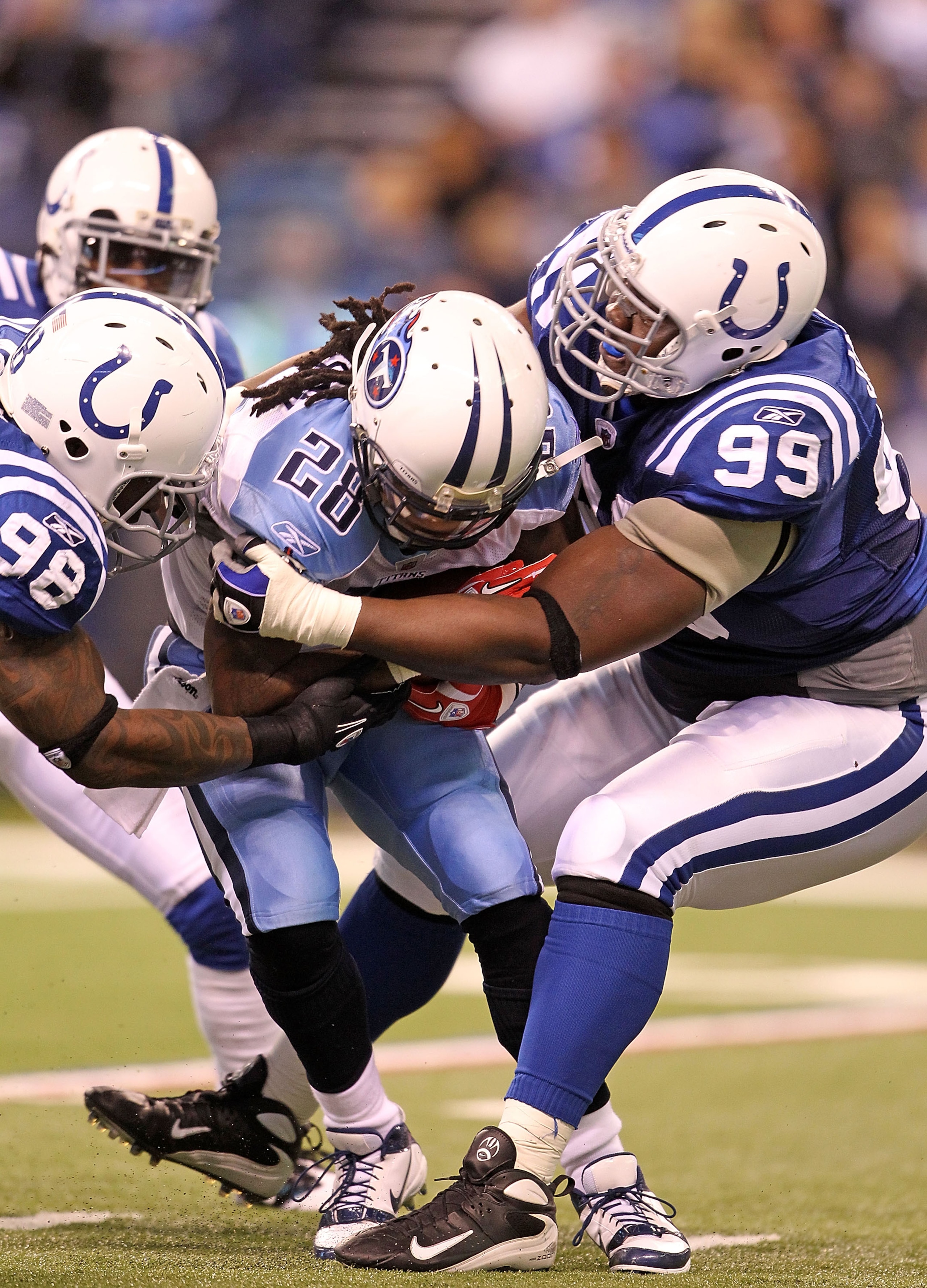 INDIANAPOLIS - JANUARY 02: Chris Johnson #28 of the Tennessee Titans is tackled by Robert Mathis #98 and Antonio Johnson #99 of the Indianapolis Colts at Lucas Oil Stadium on January 2, 2011 in Indianapolis, Indiana. the Colts won 23-20. (Photo by Andy INDIANAPOLIS - JANUARY 02: Chris Johnson #28 of the Tennessee Titans is tackled by Robert Mathis #98 and Antonio Johnson #99 of the Indianapolis Colts at Lucas Oil Stadium on January 2, 2011 in Indianapolis, Indiana. the Colts won 23-20. (Photo by Andy