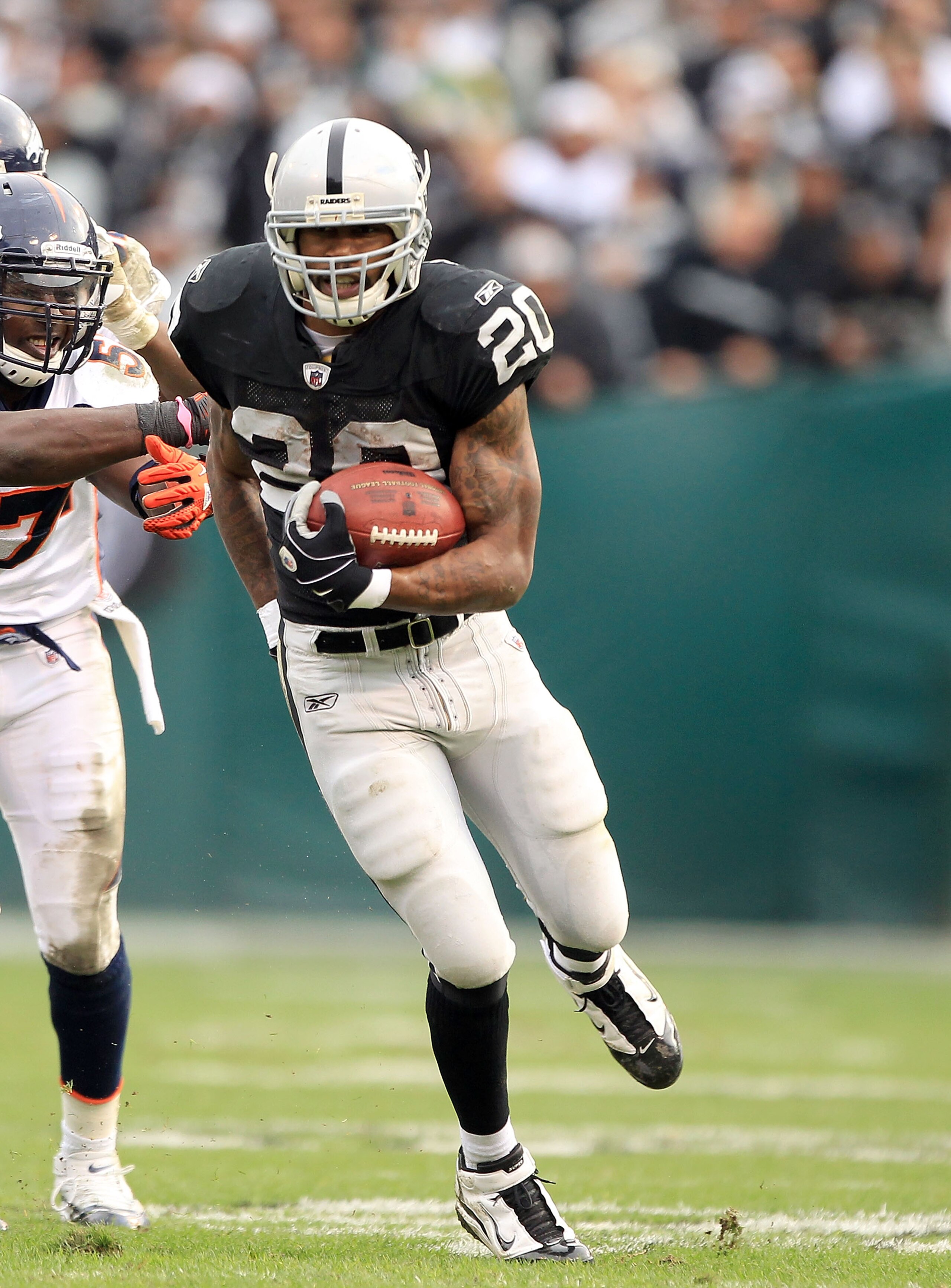 OAKLAND, CA - DECEMBER 19:  Darren McFadden #20 of the Oakland Raiders runs with the ball during their game against the Denver Broncos at Oakland-Alameda County Coliseum on December 19, 2010 in Oakland, California.  (Photo by Ezra Shaw/Getty Images)