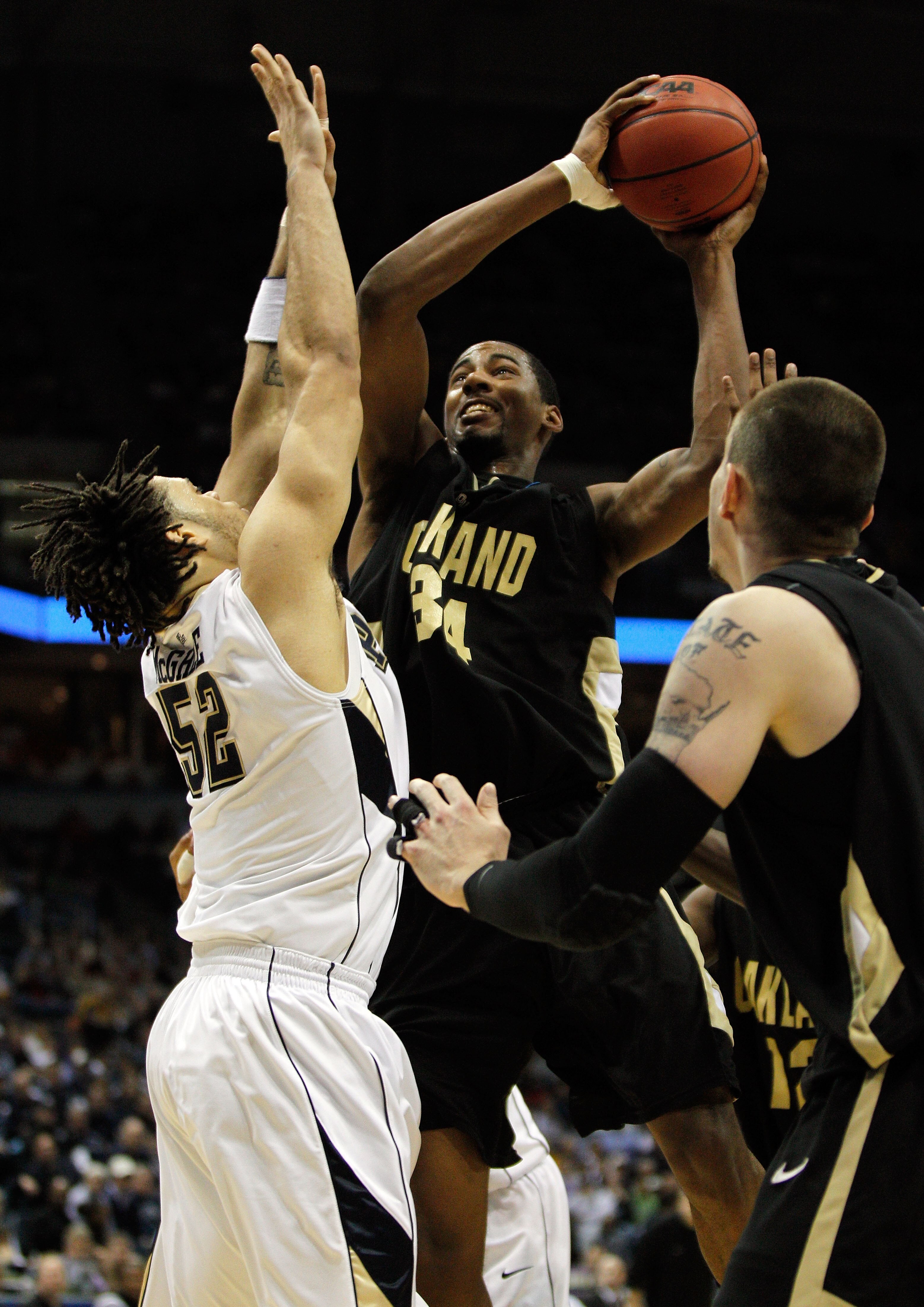 MILWAUKEE - MARCH 19:  Keith Benson #34 of the Oakland Golden Grizzlies shoots the ball over Gary McGhee #52 of the Pittsburgh Panthers in the first half during the first round of the 2010 NCAA men's basketball tournament at the Bradley Center on March 19