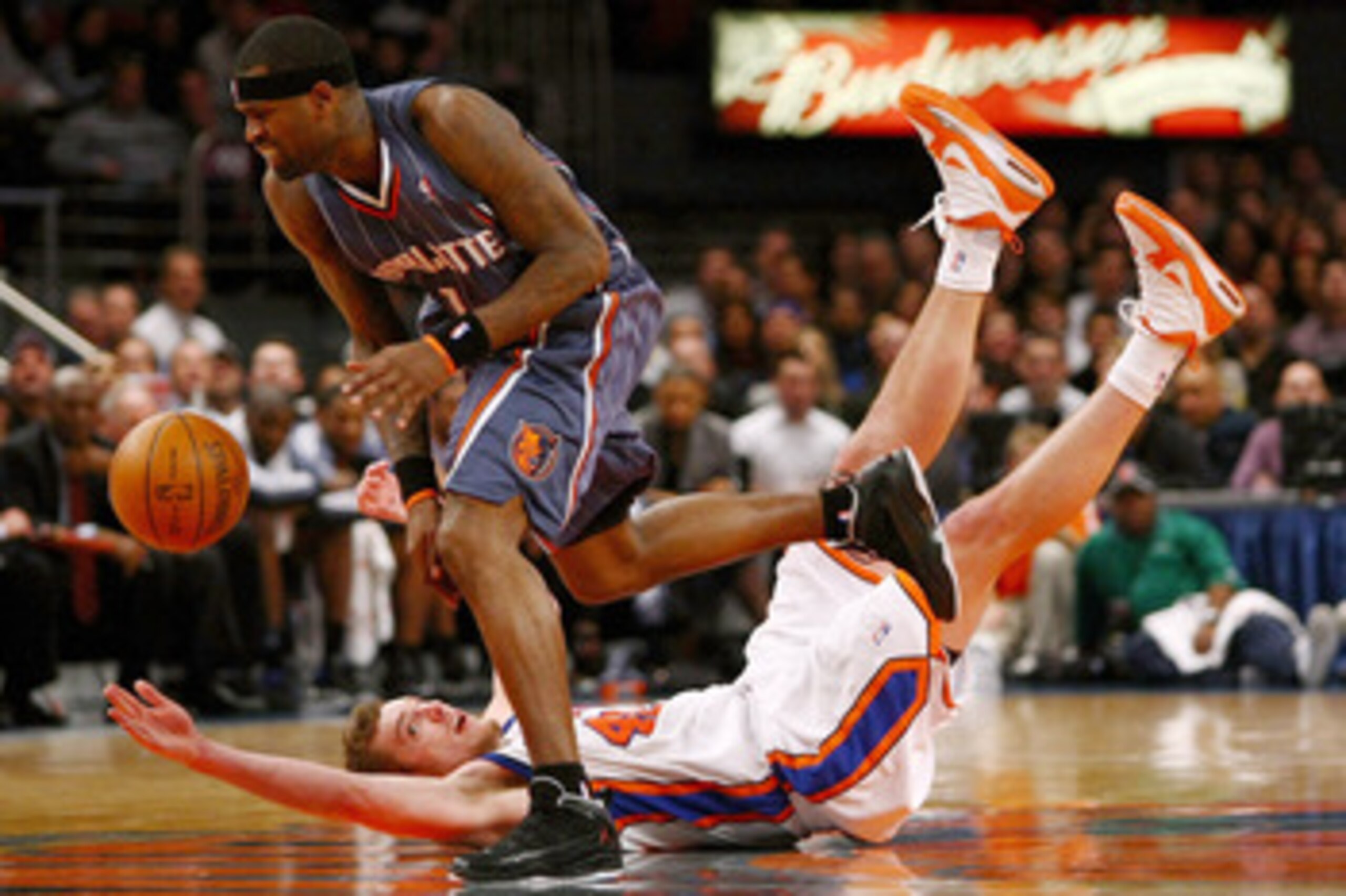 NEW YORK - JANUARY 07:  David Lee #42 of the New York Knicks falls trying to steal the ball from Stephen Jackson #1 of the Charlotte Bobcats at Madison Square Garden January 7, 2010 in New York City. NOTE TO USER: User expressly acknowledges and agrees th