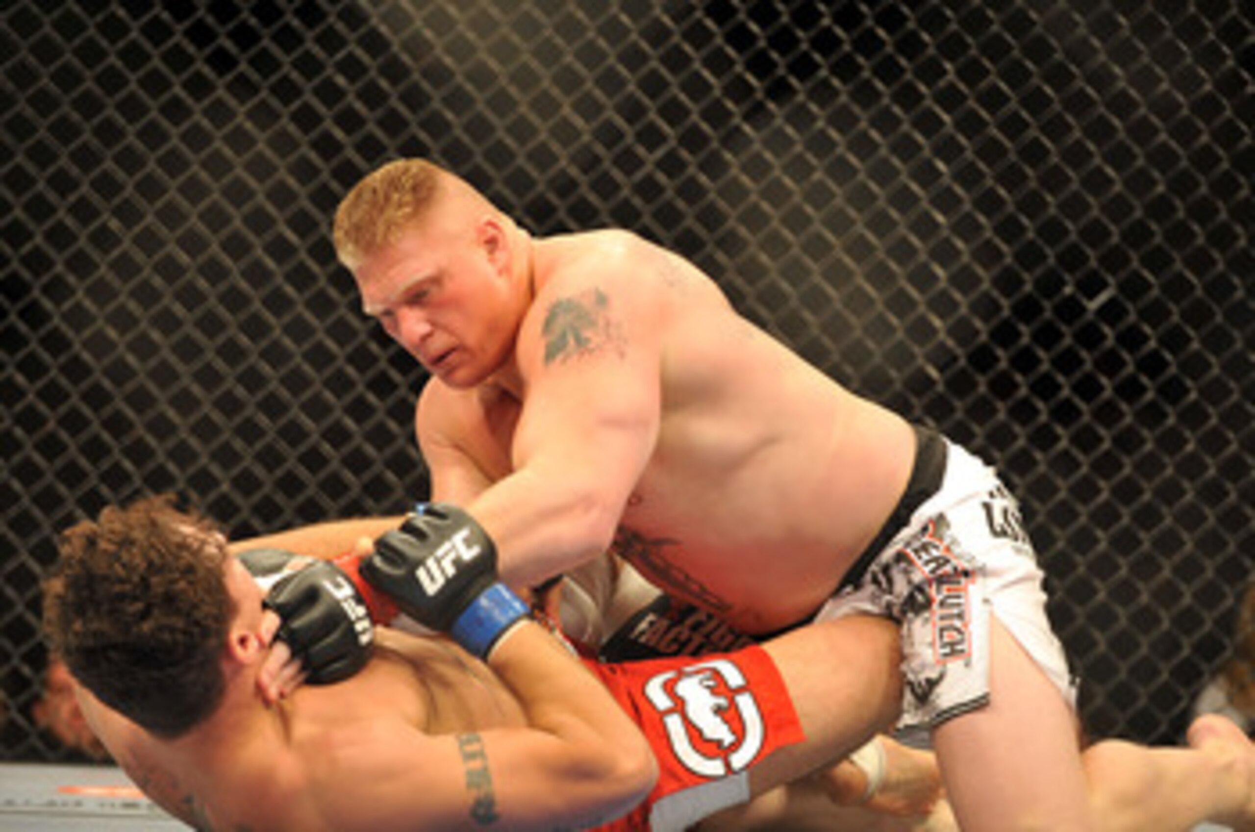LAS VEGAS - JULY 11:  Brock Lesnar holds down Frank Mir during their heavyweight title bout during UFC 100 on July 11, 2009 in Las Vegas, Nevada. Lesnar defeated Mir by a second round knockout.  (Photo by Jon Kopaloff/Getty Images)