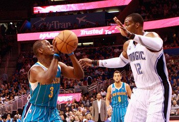ORLANDO, FL - OCTOBER 10:  Chris Paul #3 of the New Orleans Hornets attempts a shot against Dwight Howard #12 of the Orlando Magic during the game at Amway Arena on October 10, 2010 in Orlando, Florida. NOTE TO USER: User expressly acknowledges and agrees