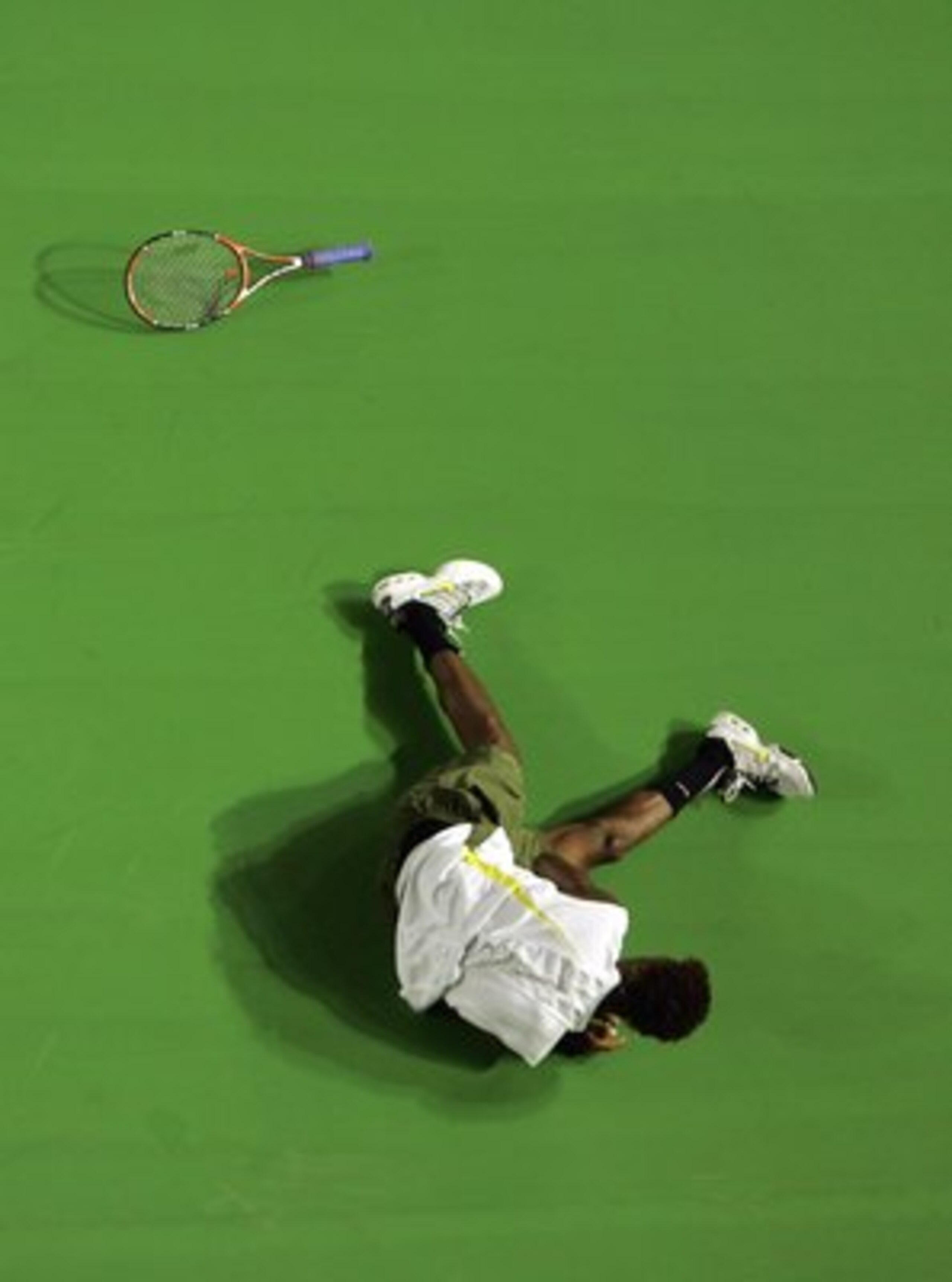MELBOURNE, AUSTRALIA - JANUARY 17:  Gael Monfils of France dives for the ball during his second round match against Marcos Baghdatis of Cyprus on day three of the Australian Open 2007 at Melbourne Park on January 17, 2007 in Melbourne, Australia.  (Photo