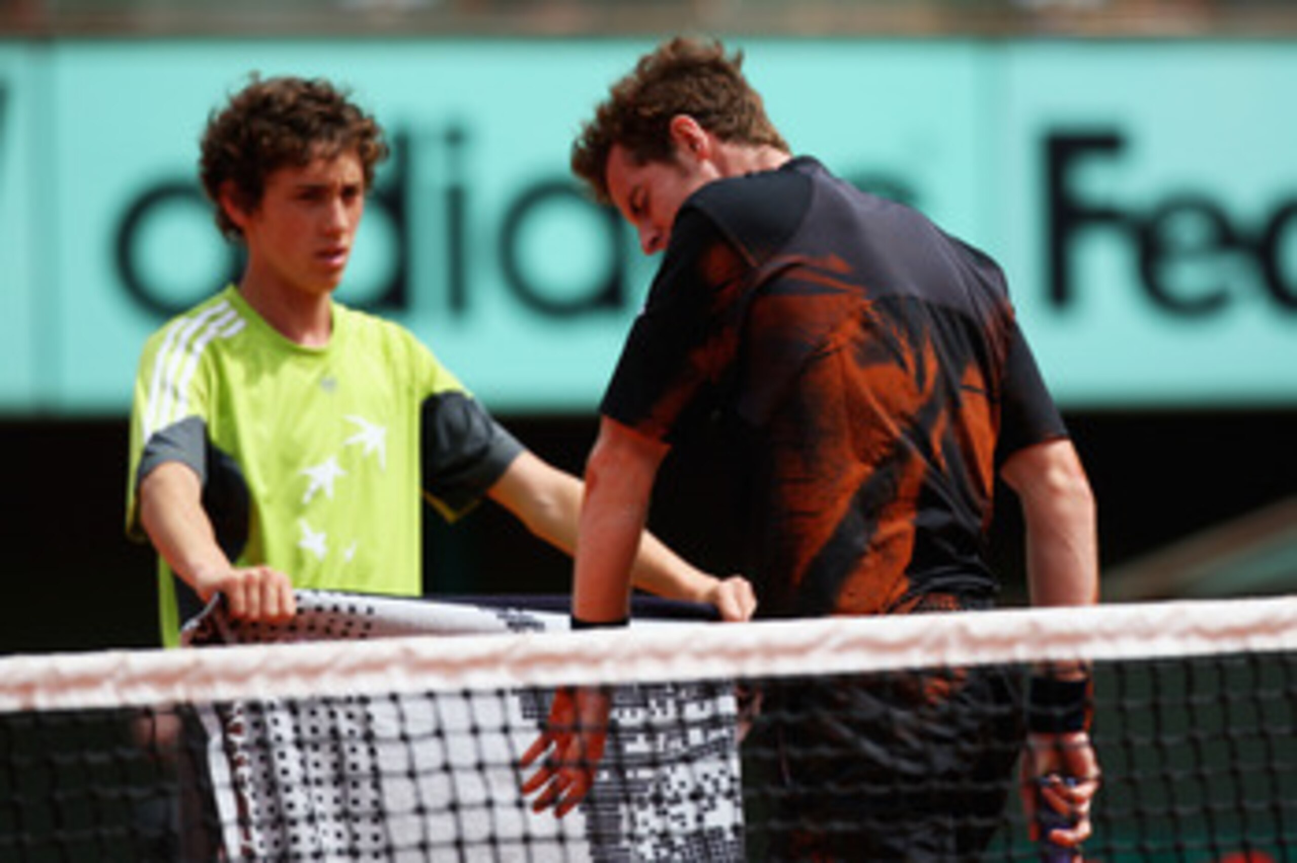 PARIS - MAY 27:  Andy Murray of Great Britain checks his elbow after falling at the net during his Men's Singles Second Round match against Potito Starace of Italy on day four of the French Open at Roland Garros on May 27, 2009 in Paris, France.  (Photo b
